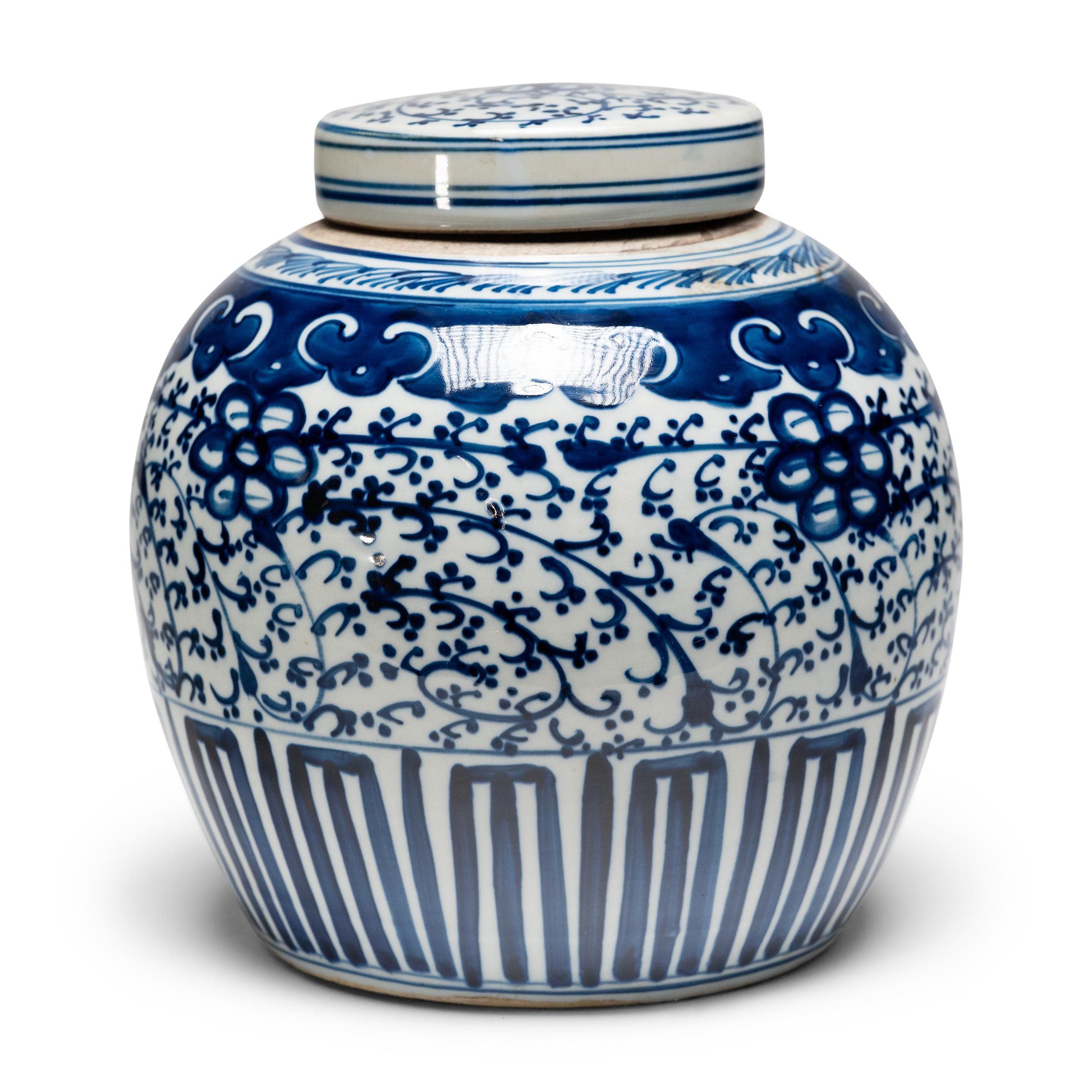 This porcelain tea leaf jar is beautifully glazed in the blue-and-white manner, with hand-painted cobalt-blue decoration against a crisp white field. The porcelain jar has a rounded form and flat lid, a traditional shape for jars used to hold