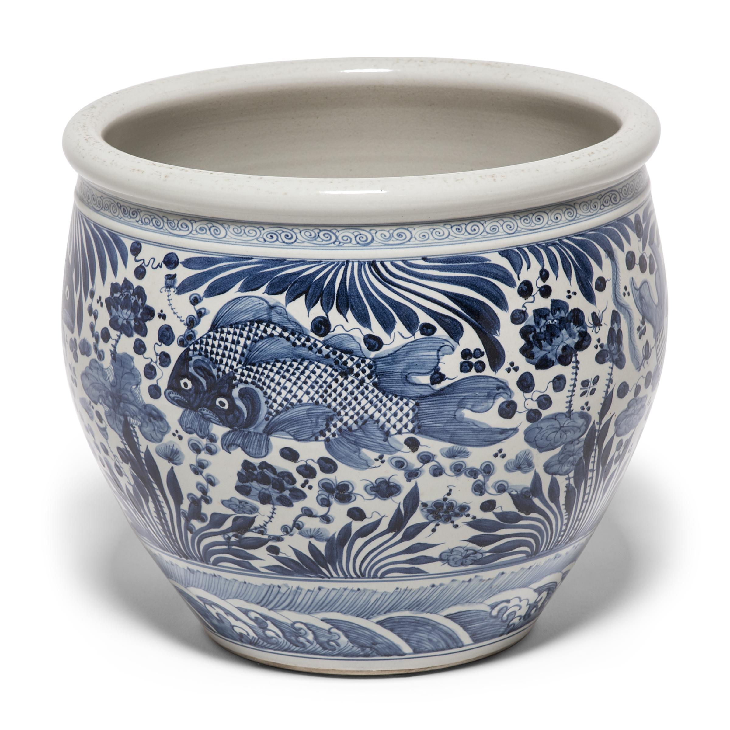 This grand, blue and white porcelain bowl is hand painted with flora and fauna of the sea, offering blessings of wealth, abundance, and the contented harmony of a fish in water. Chinese blue-and-white ceramics have inspired ceramists worldwide since