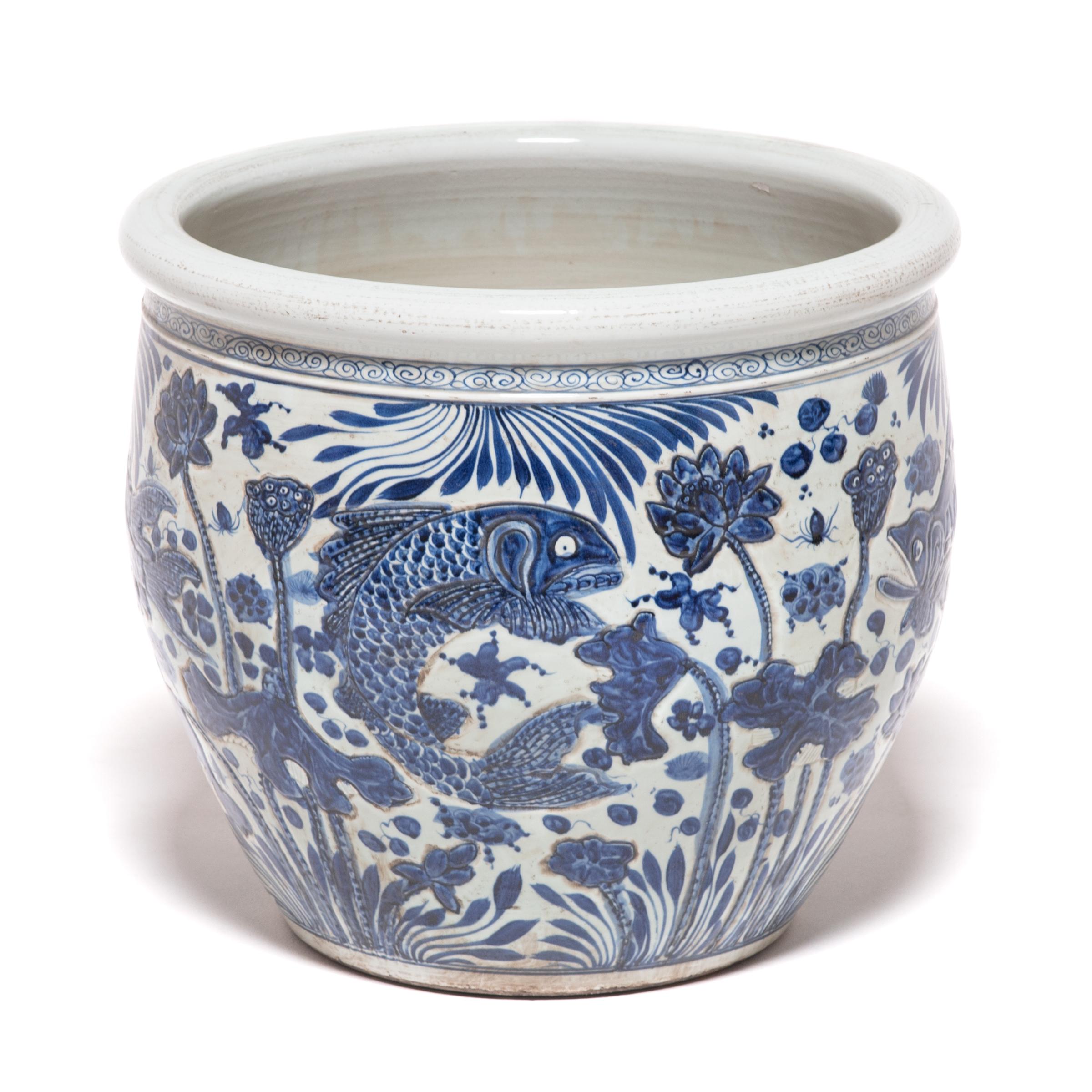 This grand, blue-and-white porcelain bowl is hand painted with flora and fauna of the sea, offering blessings of wealth, abundance, and the contented harmony of a fish in water. Chinese blue-and-white ceramics have inspired ceramists worldwide since