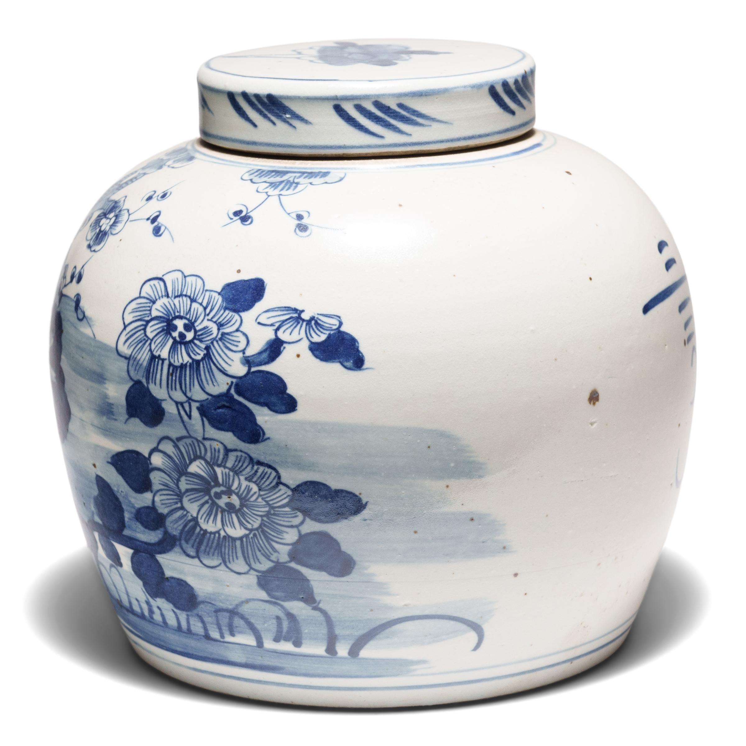 Loosely brushed with cobalt blue pigments, this round, blue-and-white storage jar is underglazed with lush garden scenery featuring the flowering plants of the four seasons. Tree peonies for spring adorn the left side, while round chrysanthemum