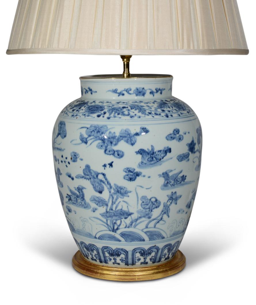 A fine Chinese blue and white vase, decorated in the Kangxi style, with ducks swimming in a watery landscape. Now mounted as a lamp with hand gilded turned base.

Height of vase: 15 1/2 in (39 cm) including gilt bases, excluding electrical fitments