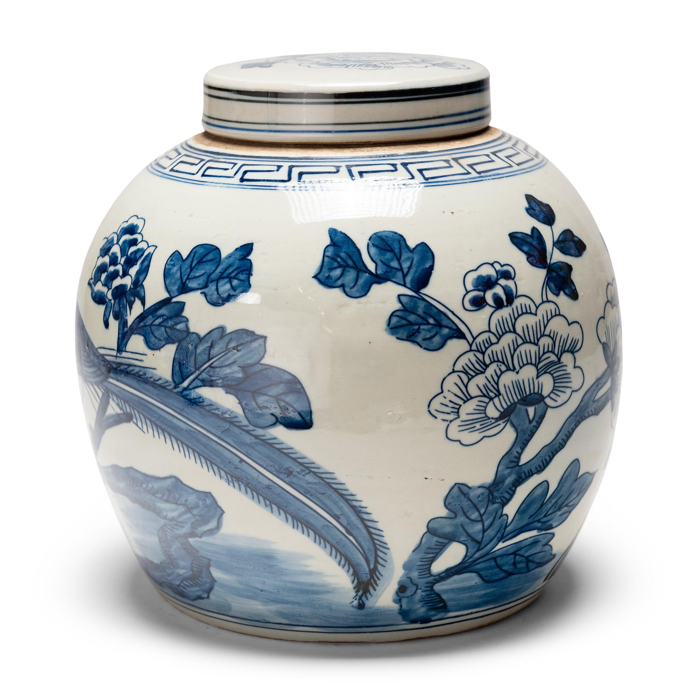 This porcelain tea leaf jar is beautifully glazed in the blue-and-white manner, with hand-painted cobalt-blue decoration against a crisp white field. The jar has a rounded form and flat lid, a traditional shape for jars used to hold Chinese tea