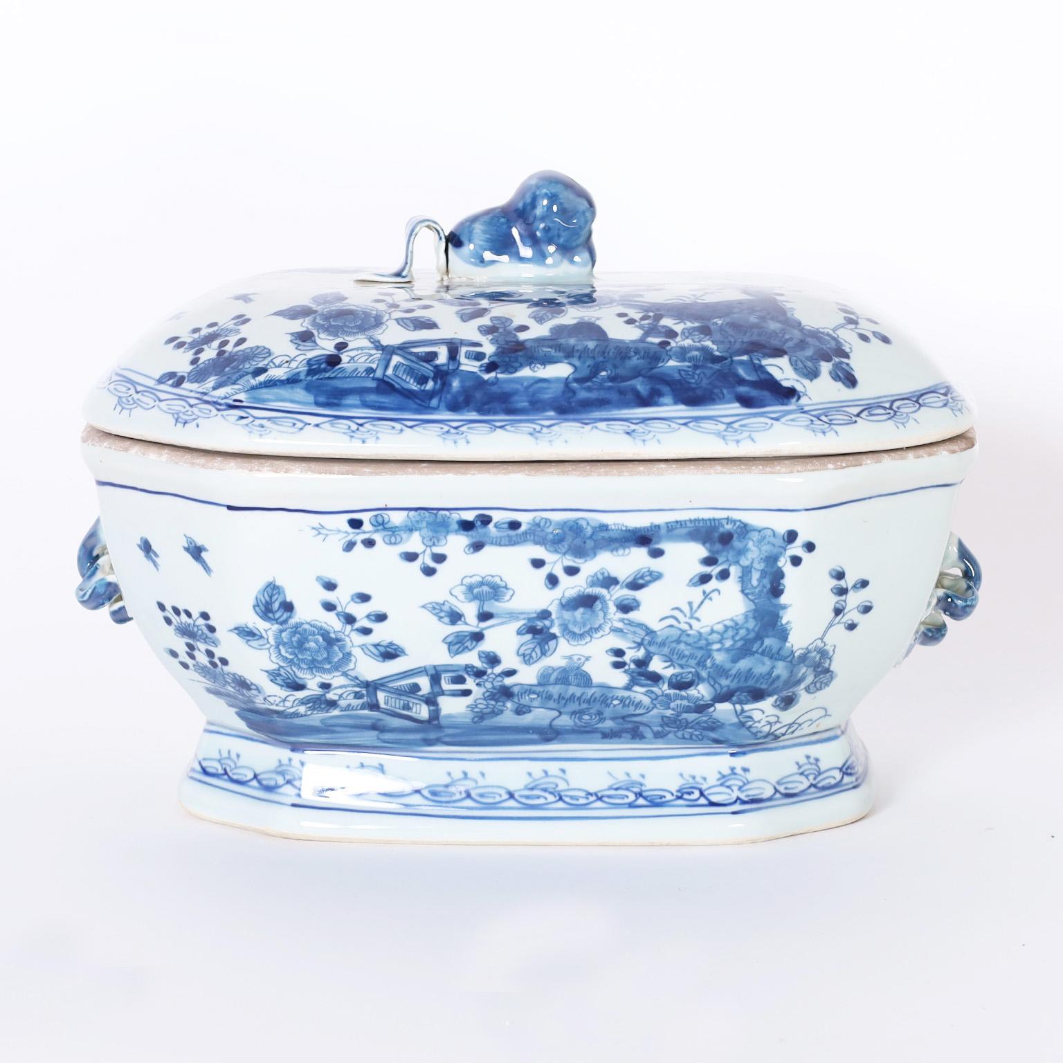 Chinese blue and white porcelain lidded bowl or tureen hand decorated with fauna and flora featuring floral handles on the sides and a figural handle on the top. Two are available.