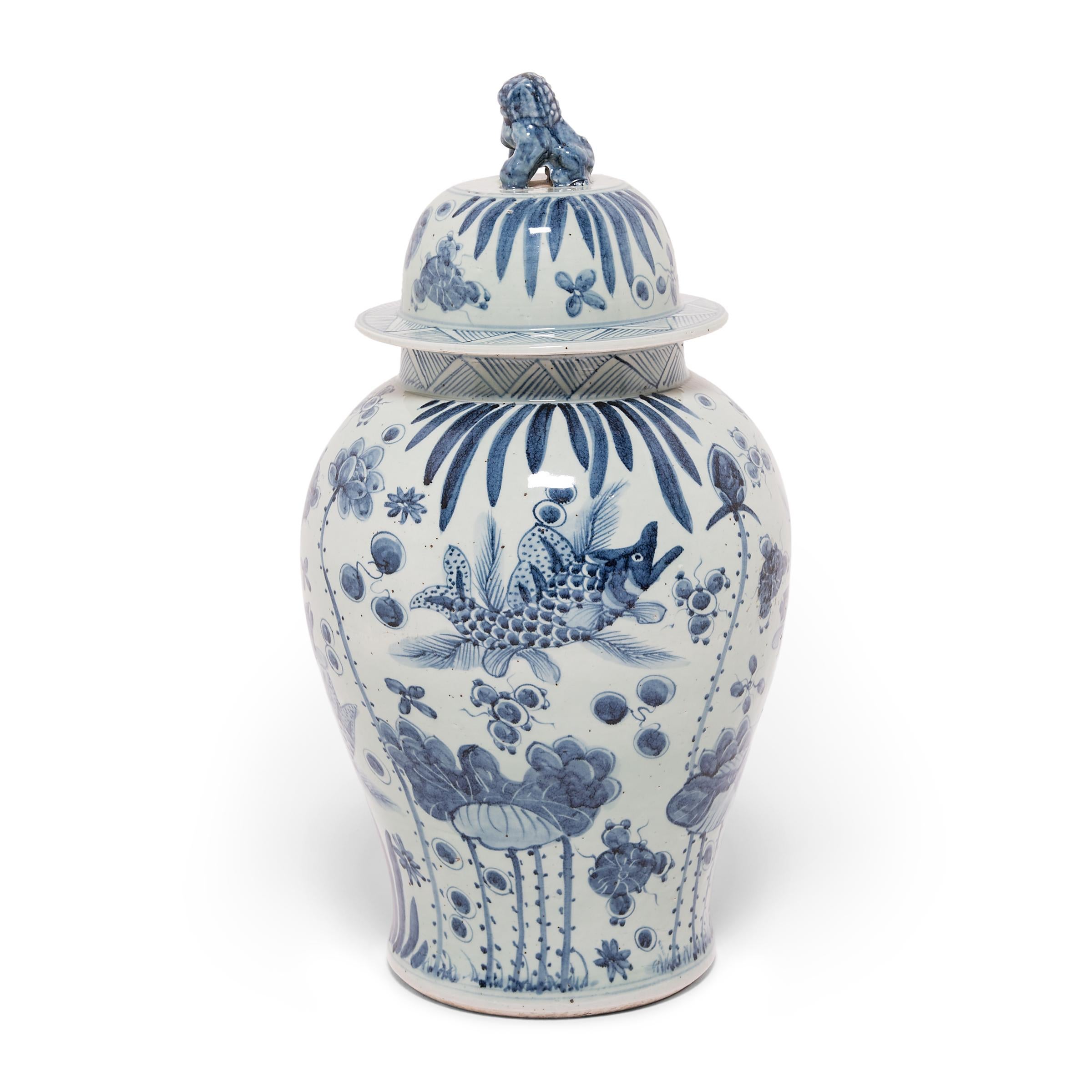 This blue-and-white covered jar is hand-painted with flora and fauna of the sea, offering blessings of wealth, abundance, and the contented harmony of a fish in water. Chinese blue-and-white ceramics have inspired ceramists worldwide since cobalt