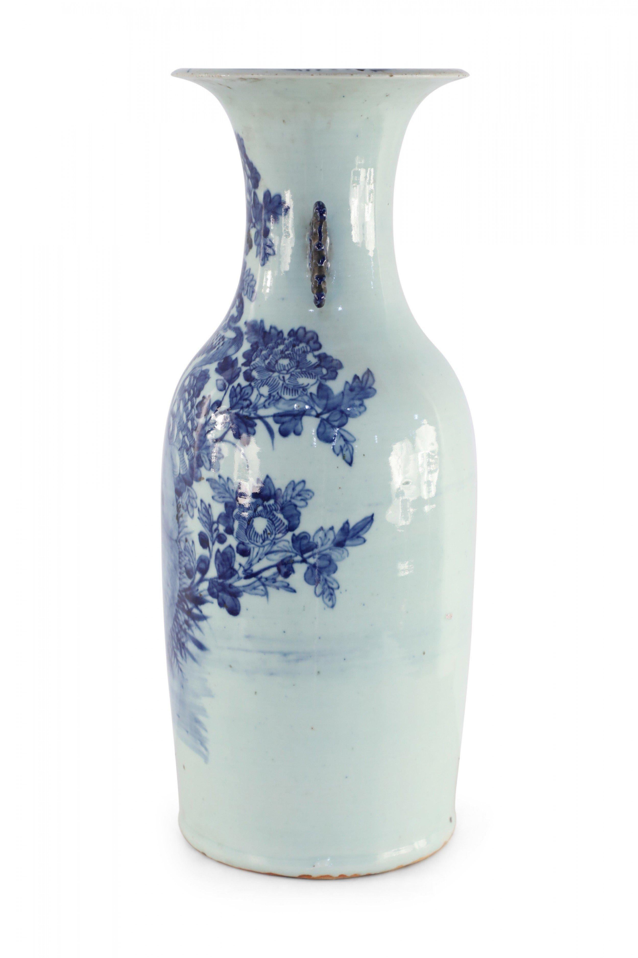 Antique Chinese (late 19th century) large off-white, porcelain urn with a blue peacock amid florals and two blue scrolled handles along the neck.
     