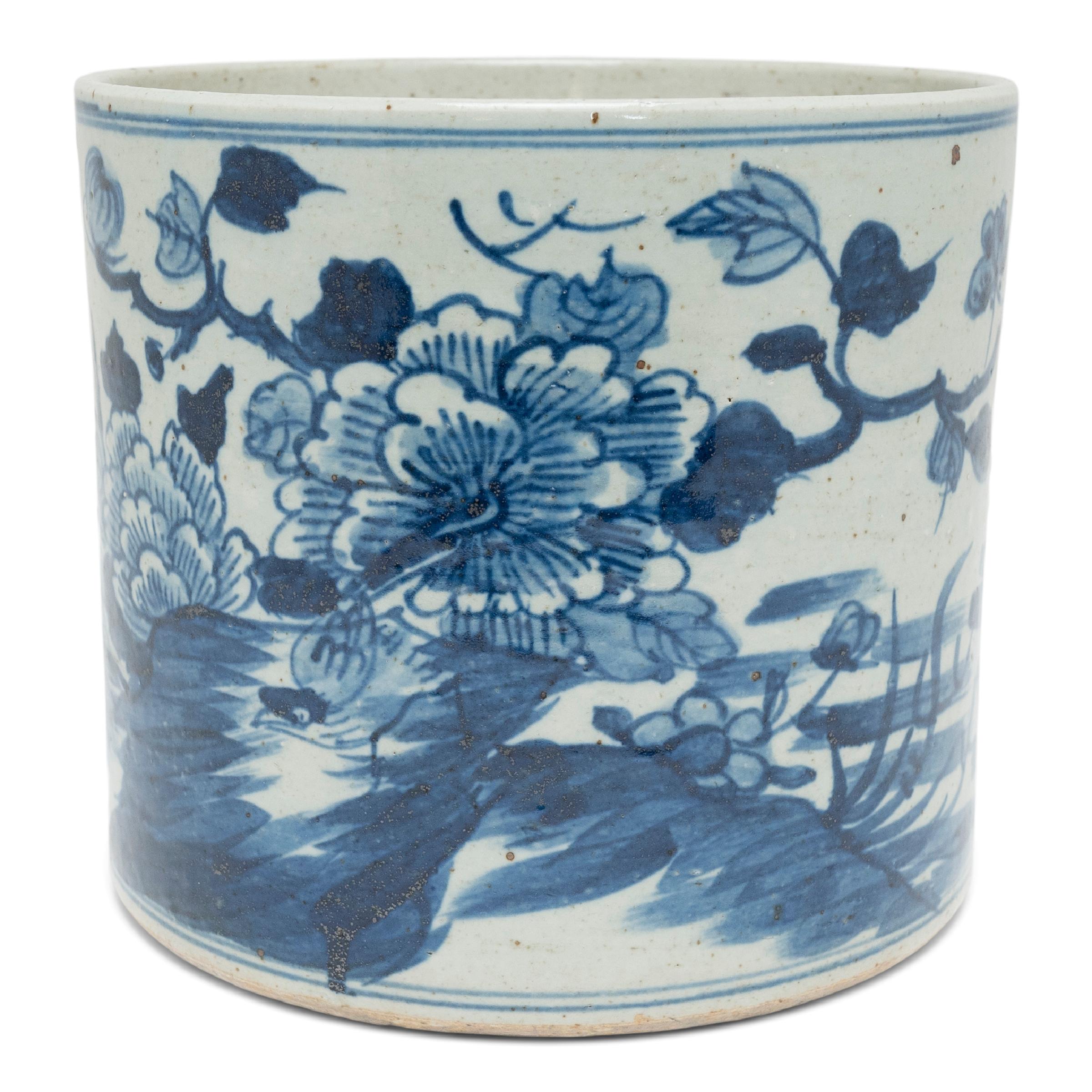 Set alongside the four treasures of the study - the calligraphy brush, ink, paper, and inkstone - a brush pot, or bitong, was an essential fixture of the scholars' desk. This stoneware brush pot beautifully exemplifies this traditional form with the