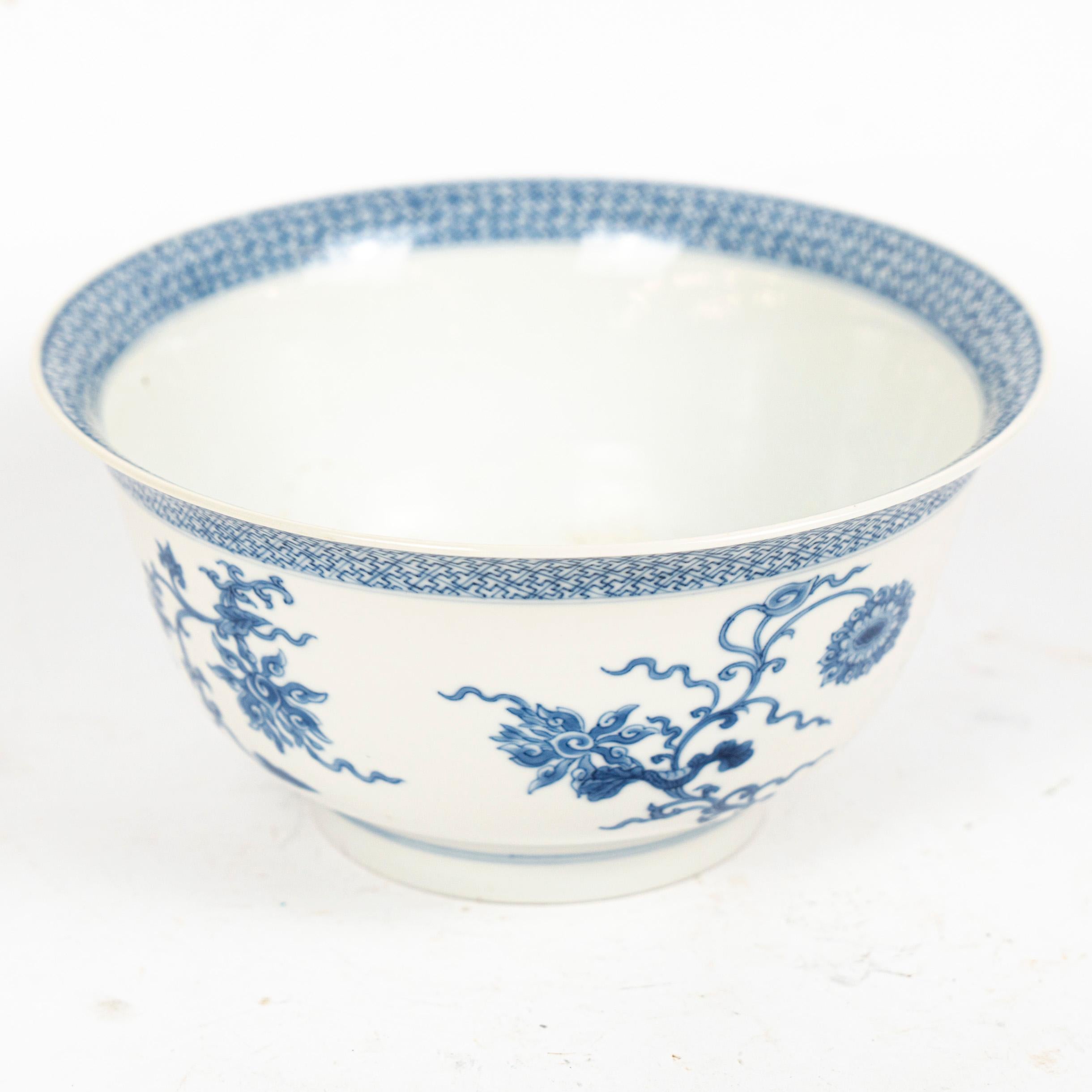 Fino cuenco de porcelana china, decorado en azul cobalto bajo vidriado con motivos de lotos elegantemente desplazados y bordes calados clásicos. El diseño está ejecutado con claridad y precisión, captando la refinada estética de la porcelana de