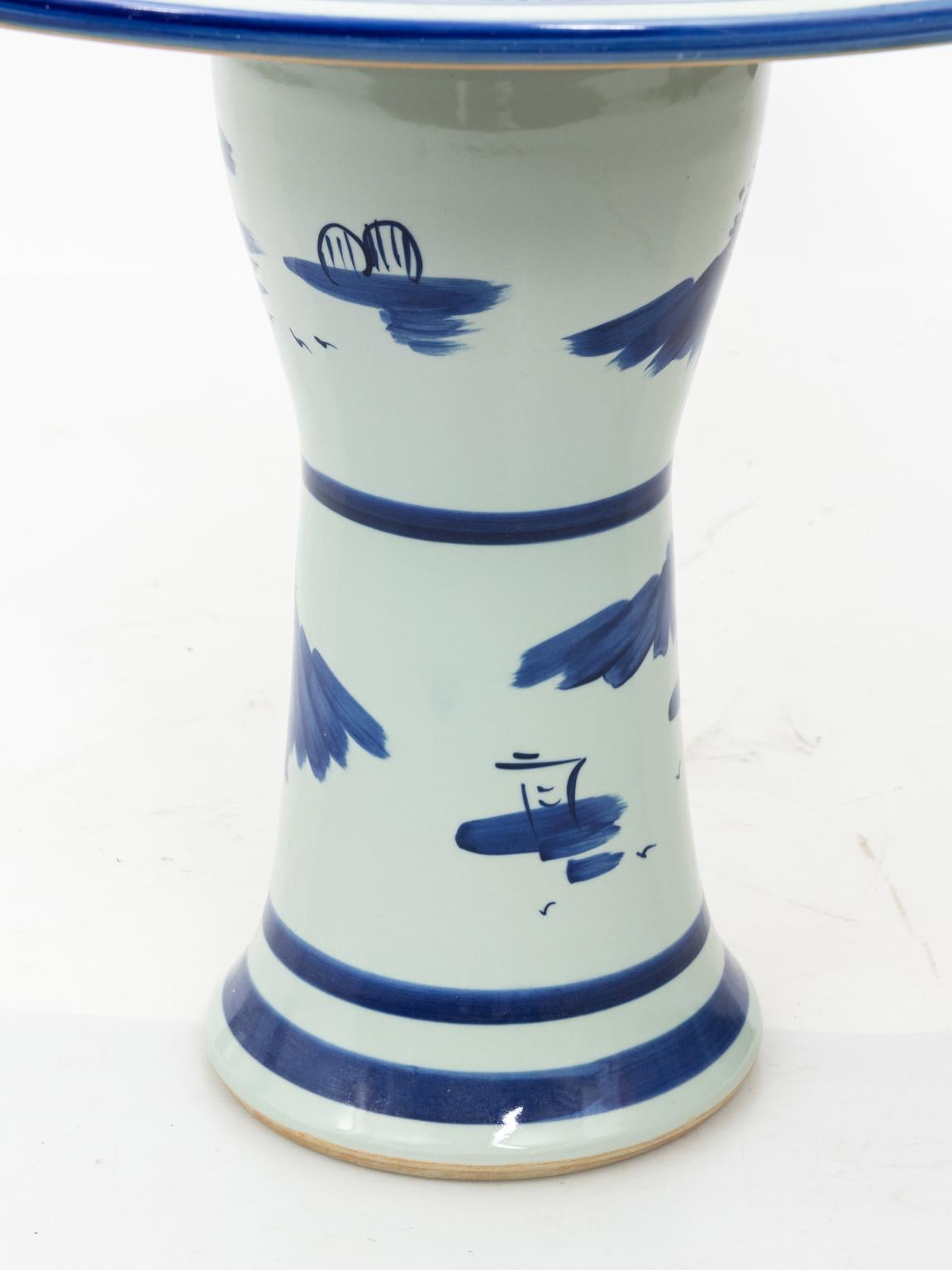 Blue and white painted Chinese porcelain garden table with four matching stools, circa 20th century. Please note of wear to the glaze finish. The stools measure 9.00 inches wide by 14.00 inches height by 9.00 inches depth.