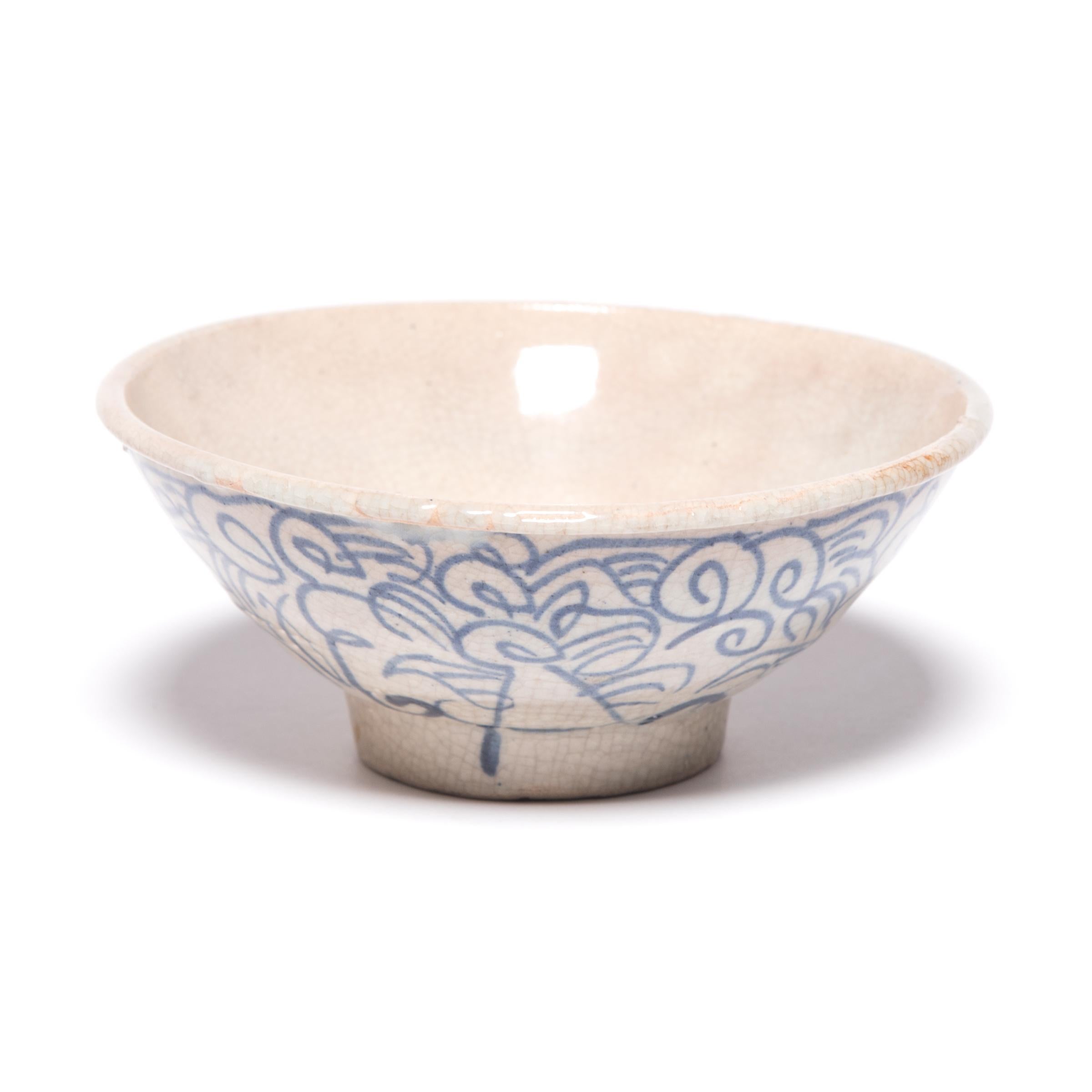 This late 19th century footed bowl would have been offered by Chinese traders traveling along the Silk Road in exchange for spices or gems. The Chinese artisans who hand painted it with scrolls, loops, and crossed lines thought the meandering