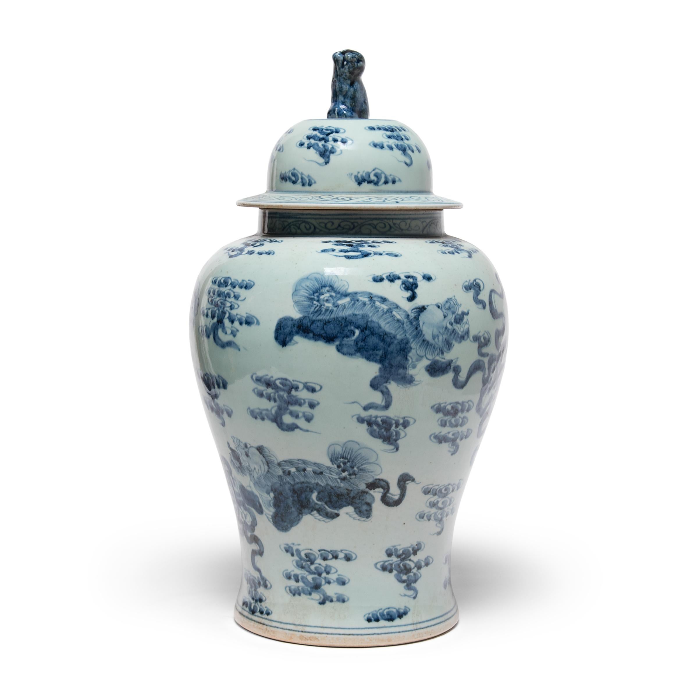 Images of shizi, a lion-dog symbol of power and strength of character, cavort among the stylized clouds of heaven on this hand painted covered jar. Created by a contemporary artisan, this baluster jar is a beautiful continuation of the tradition of