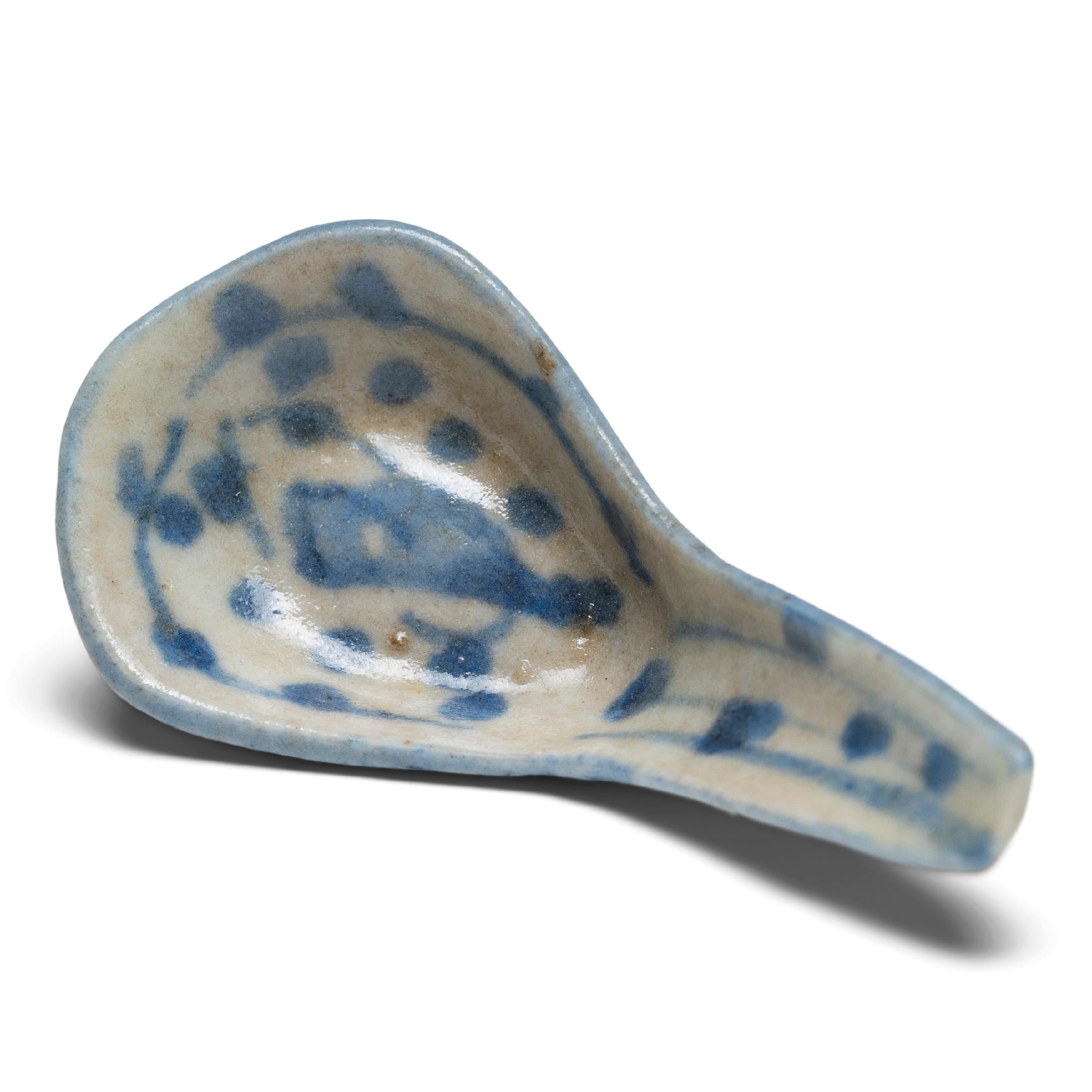 A delicate example of the time-honored practice of blue-and-white ceramics, this 19th-century porcelain soup spoon was likely used as an everyday eating utensil. Used in China as early as the Shang dynasty (1600 - 1046 B.C.), spoons predated