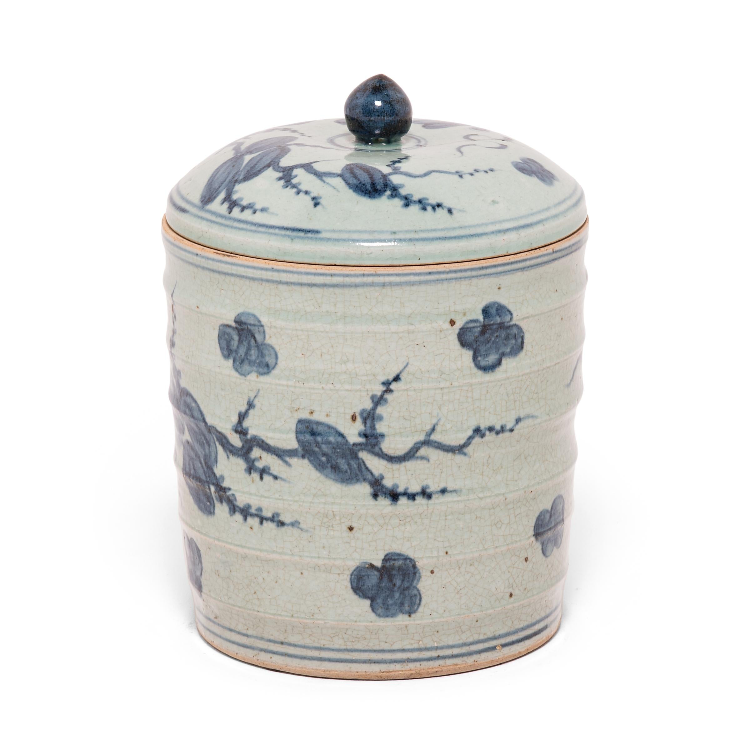 A lidded jar of this scale would have originally been used to store bushels of tea leaves. This contemporary example is hand painted with a cherry blossom motif representing feminine beauty. Freely brushed in dark blue, the artist’s expressive
