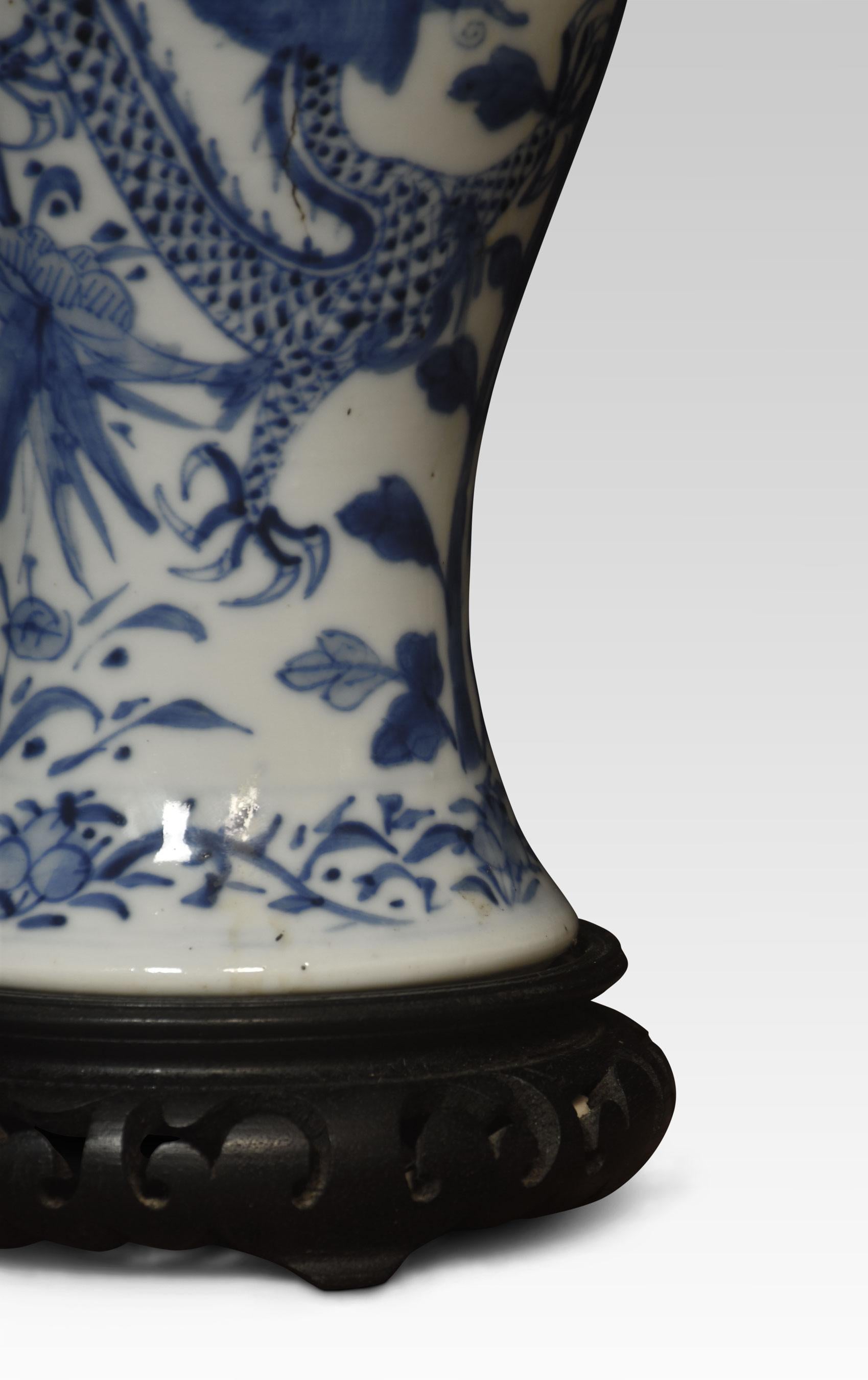 Chinese blue and white vase lamp decorated with oriental dragons and foliage on ebonies pierced base.
Dimensions :
Height 14 inches
Width 5 inches
Depth 5 inches.