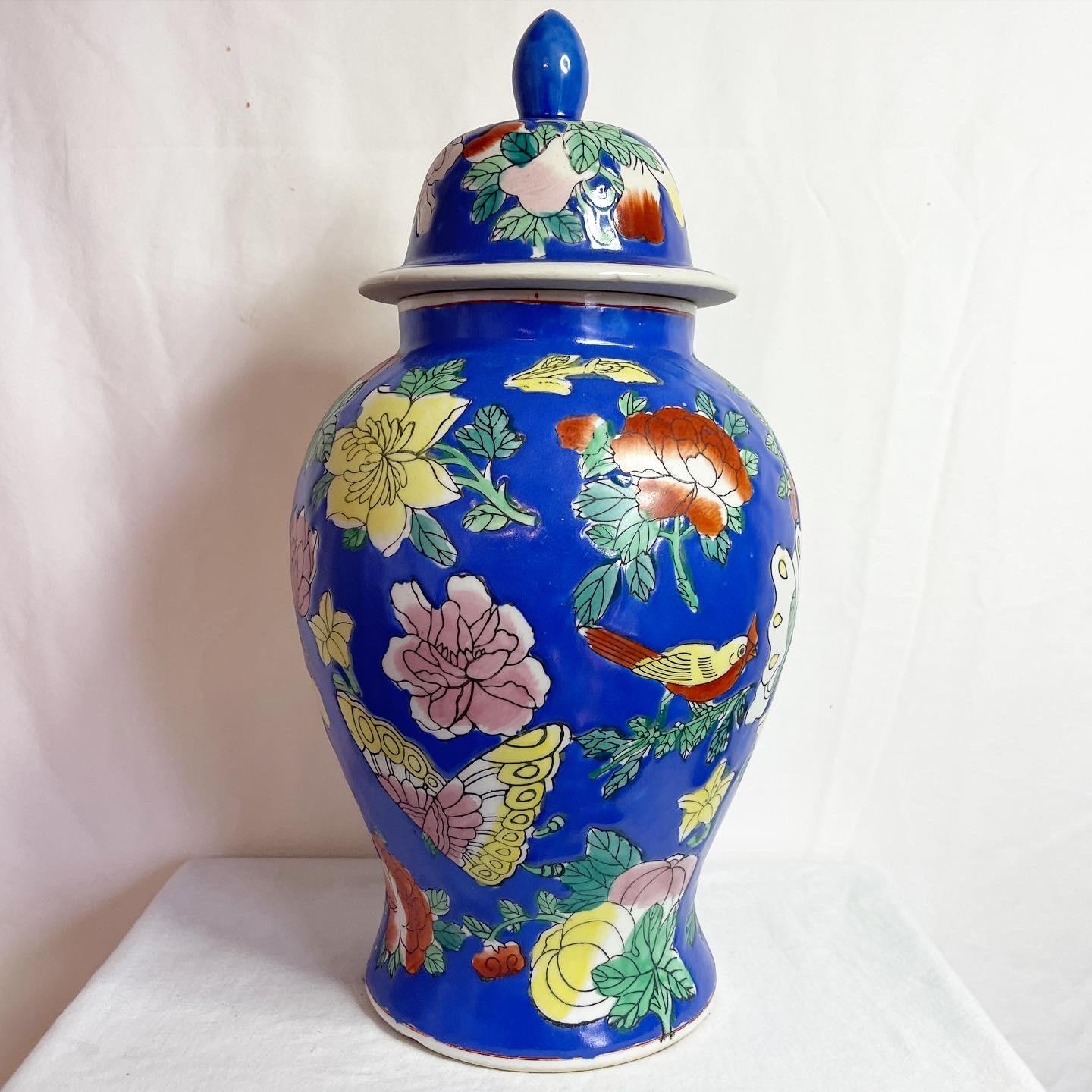 Exceptional Chinese ceramic ginger jar. Features a hand painted blue finish with colorful flowers and butterflies.
 