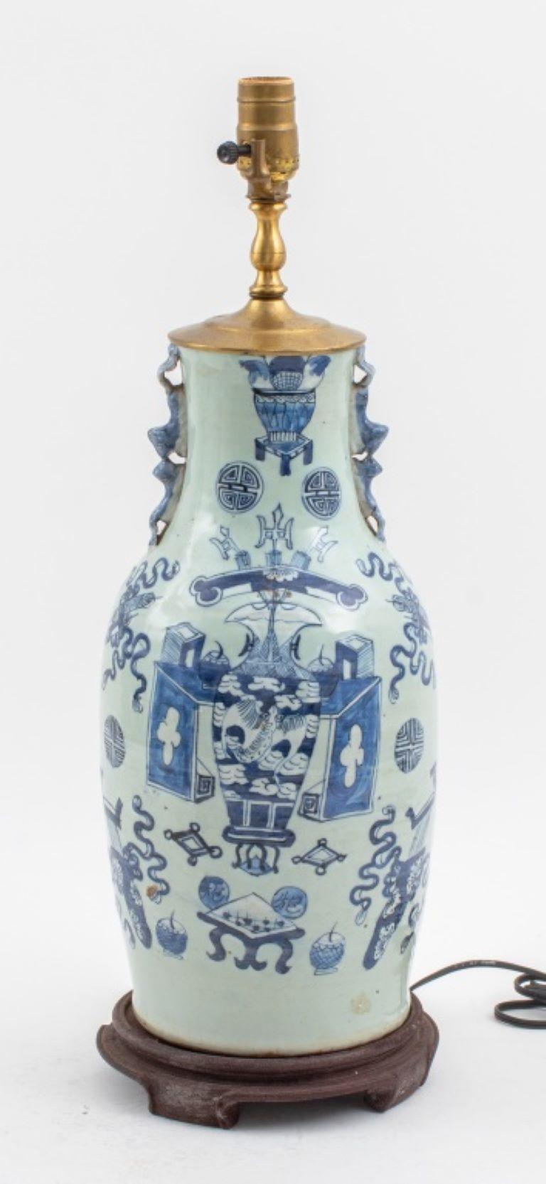 Vase balustre en céramique chinoise à décor peint à la main en bleu sur fond céladon, deux anses en forme d'écureuils s'embrassant, monté sur une base en bois et encastré dans une lampe. 