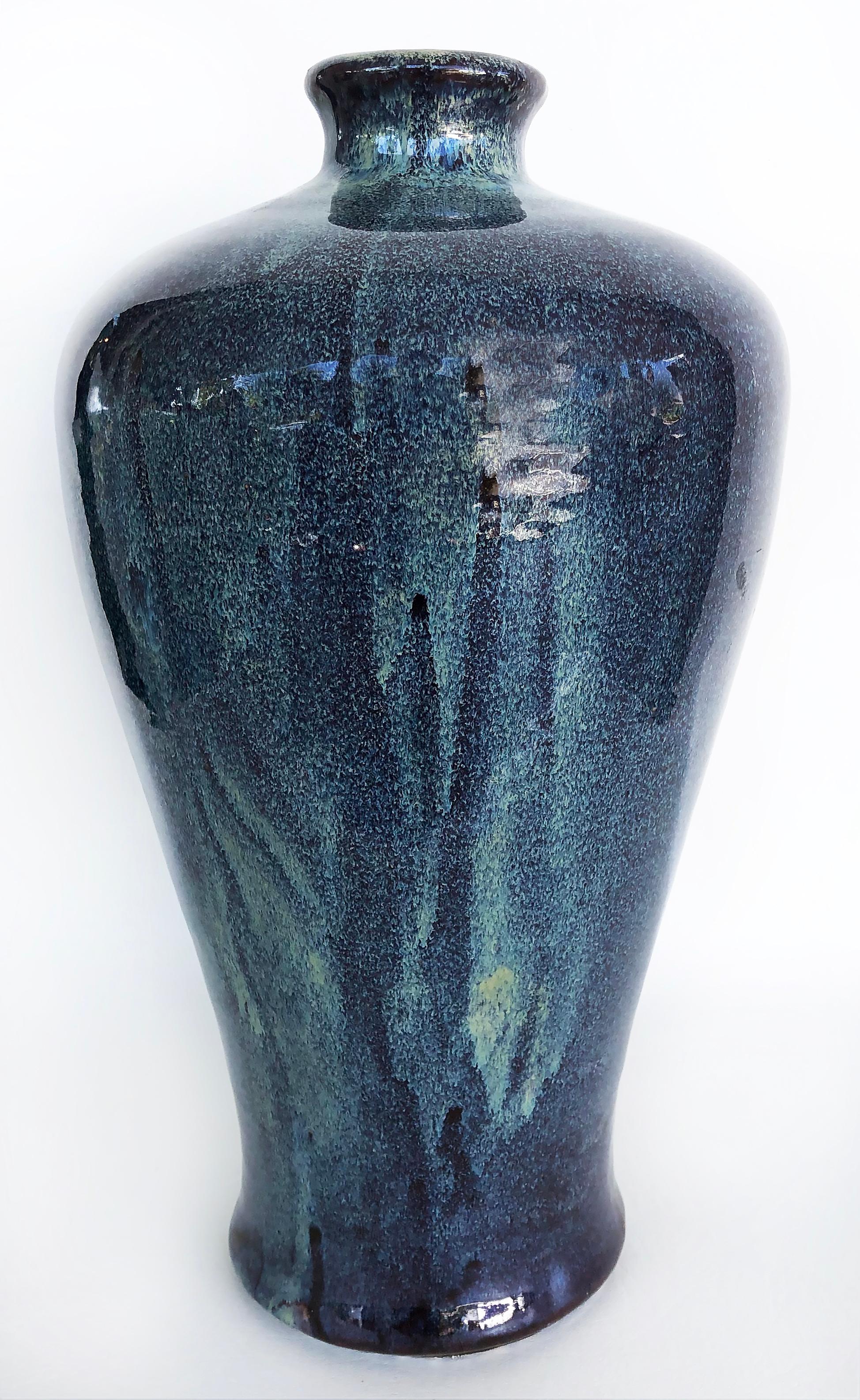 Chinese blue drip glazed ceramic urn vases, a pair.

Offered for sale is a pair of substantial Chinese blue ceramic urn-form vases with drip-glaze finishes. The vases are created with grey clay and have hand-glazed drip finishes that vary and