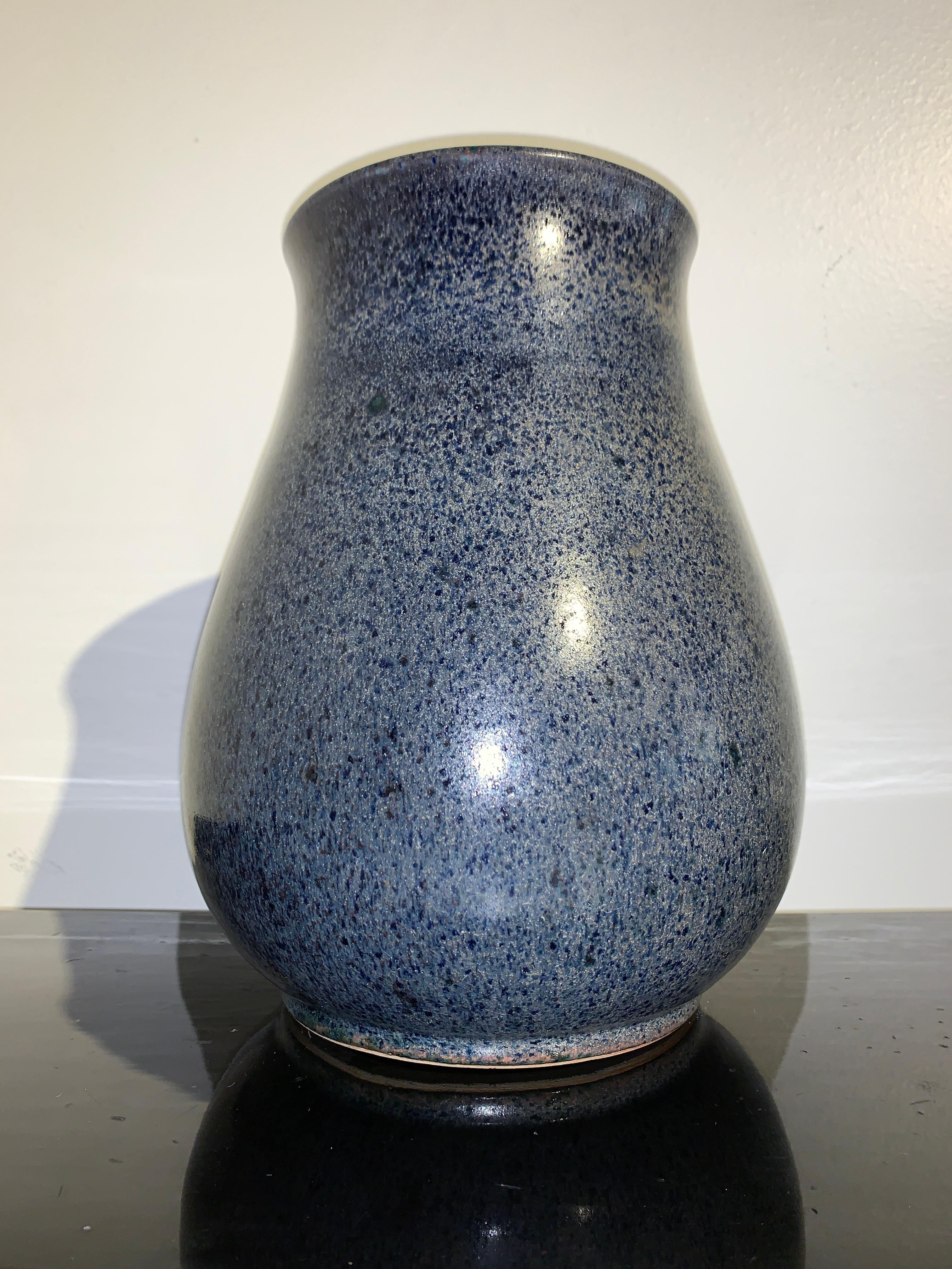 An unusual and spectacular Chinese monochrome blue flambé-glazed hu form porcelain vase, Qing Dynasty, 19th century, China. 

The hu vase is heavily potted with elegant proportions. Set on a short recessed foot, the rounded pear shaped body rises