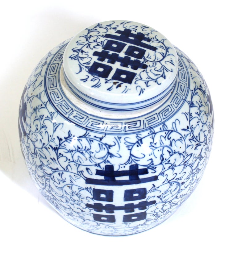 Chinese blue and white ceramic lidded ginger jar painted with foliate decoration. In great vintage condition with age-appropriate wear.
