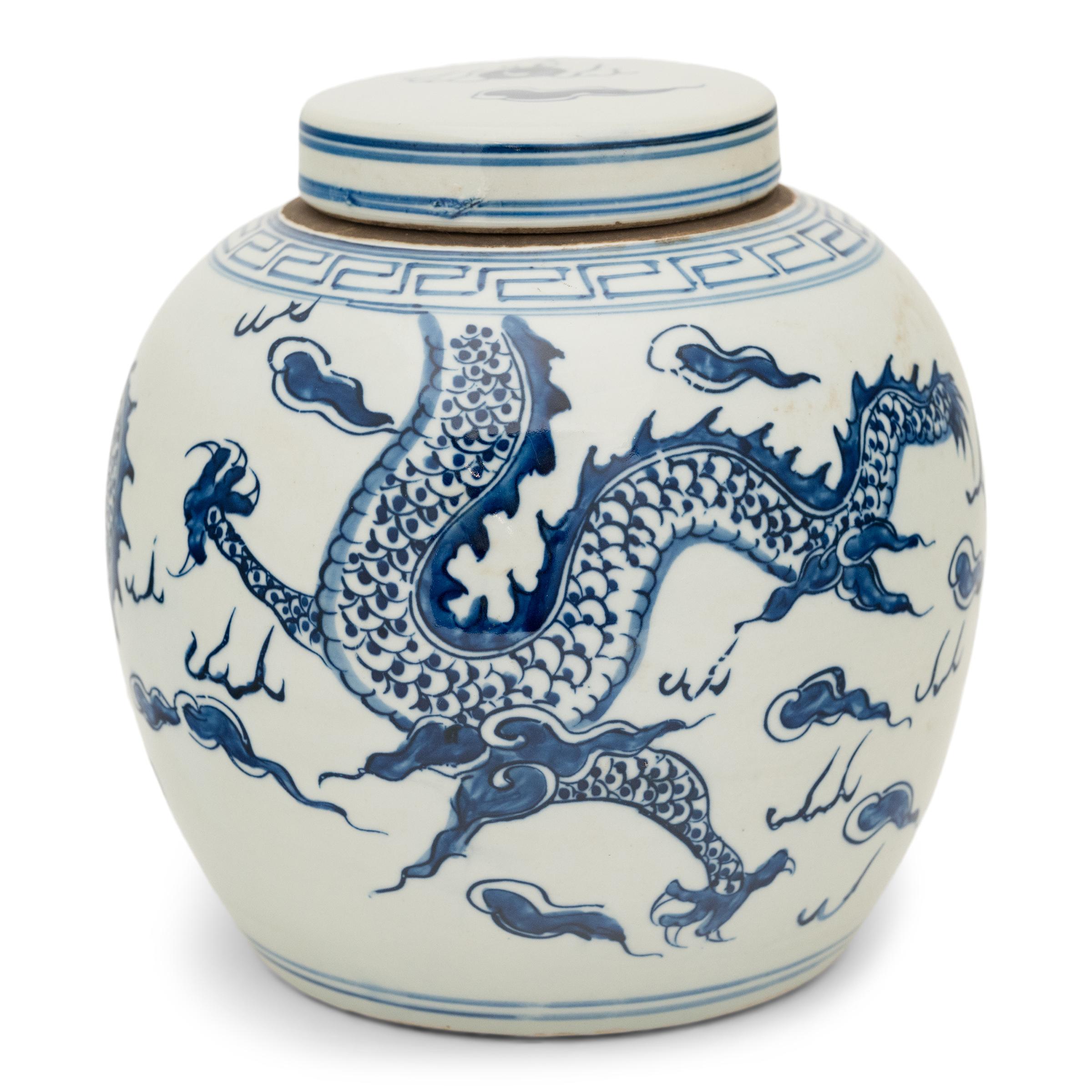 This large porcelain jar is beautifully glazed in the classic blue-and-white manner, with hand-painted cobalt-blue decoration against a crisp white field. The jar has a rounded form and flat lid, a traditional shape for jars used to hold Chinese tea
