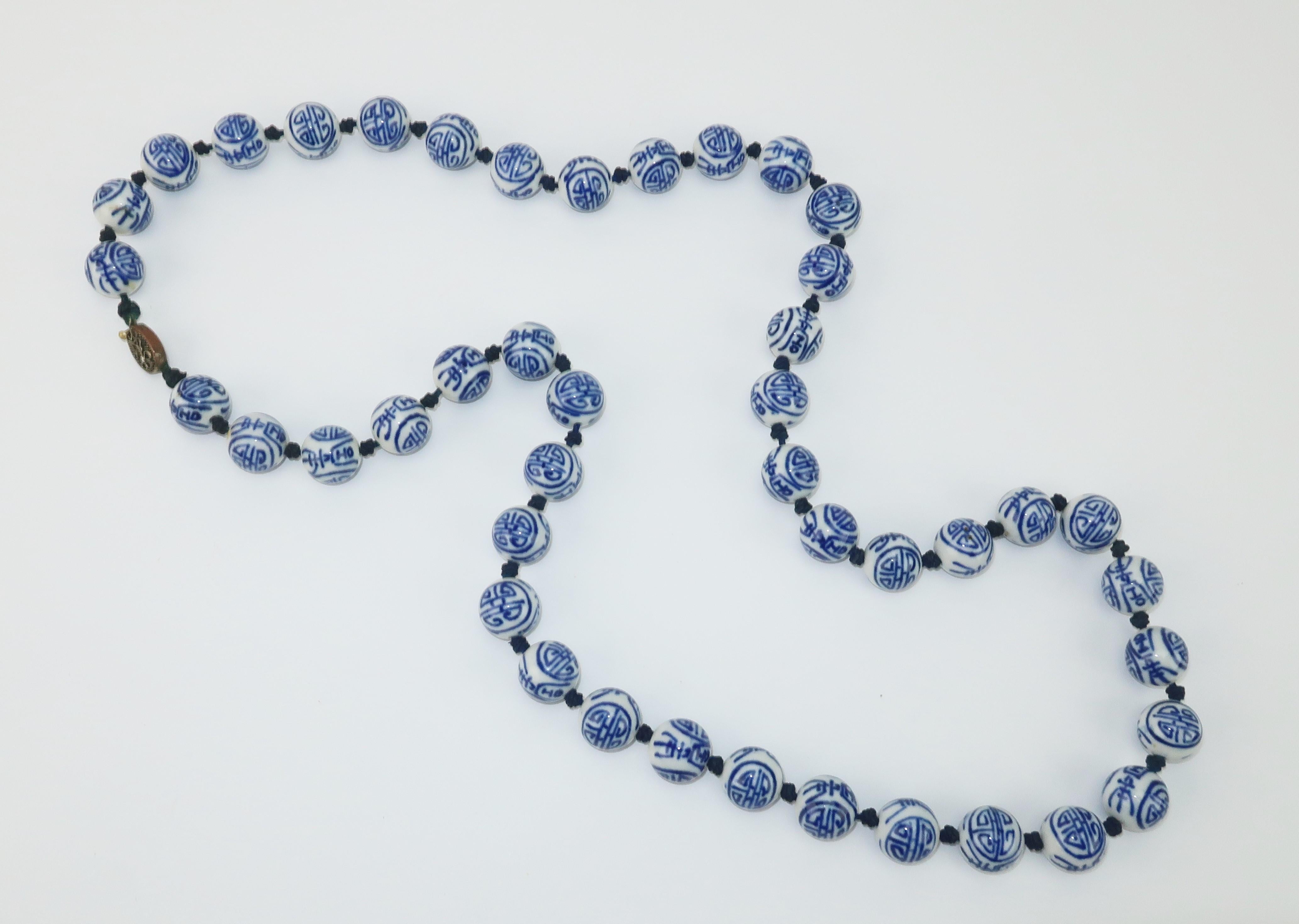1950's blue and white Chinese porcelain beads strung with knotted silk cord and outfitted with a brass filigree push clasp closure.  No maker's mark.  Wear as a single strand or double up to wear as a choker.
CONDITION
Good vintage condition with