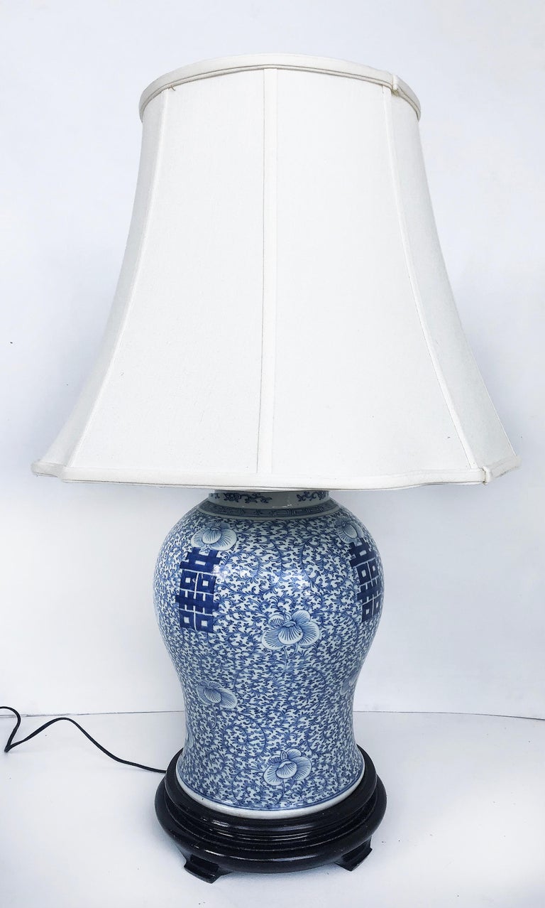Chinese blue & white porcelain ginger jar table lamps with ebonized wood stands

Offered for sale is a pair of Chinese blue and white porcelain ginger jar lamps that are mounted on ebonized wood stands. Blue and white Asin-themed porcelain is a