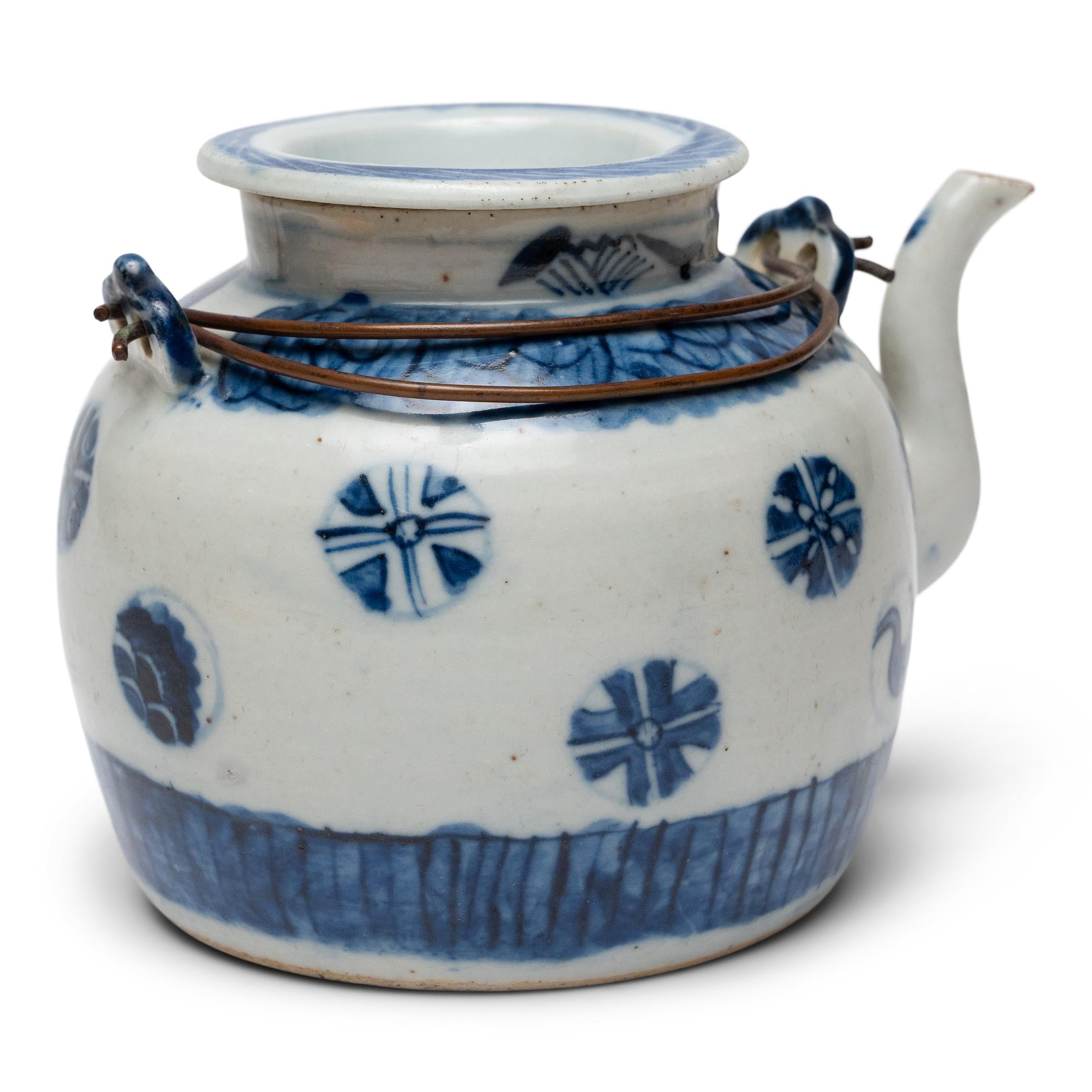 This blue-and-white porcelain teapot dates to the early 20th century and would have been used as either a teapot for brewed tea or as a ewer for dispensing boiled water during tea ceremony. The provincial teapot is shaped with rounded sides, a
