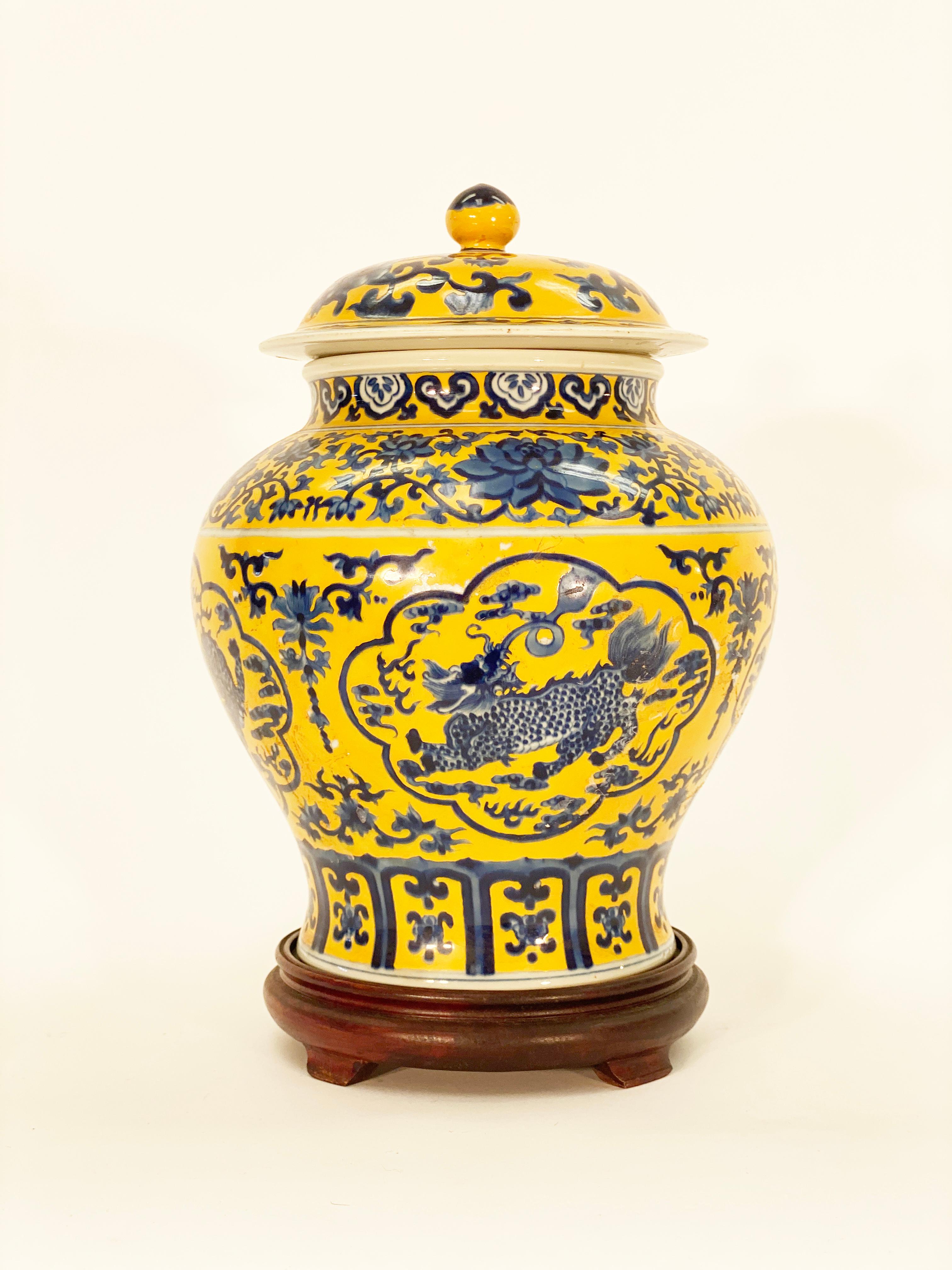 A Classic Chinese underglaze ceramic lidded ginger jar with blue and yellow enamel painting depicting daisy chains, Lotus flowers and Dragon scenes. This is hallmarked for Jaiqing Dynasty but we believe it to be later. 

Measures: 11