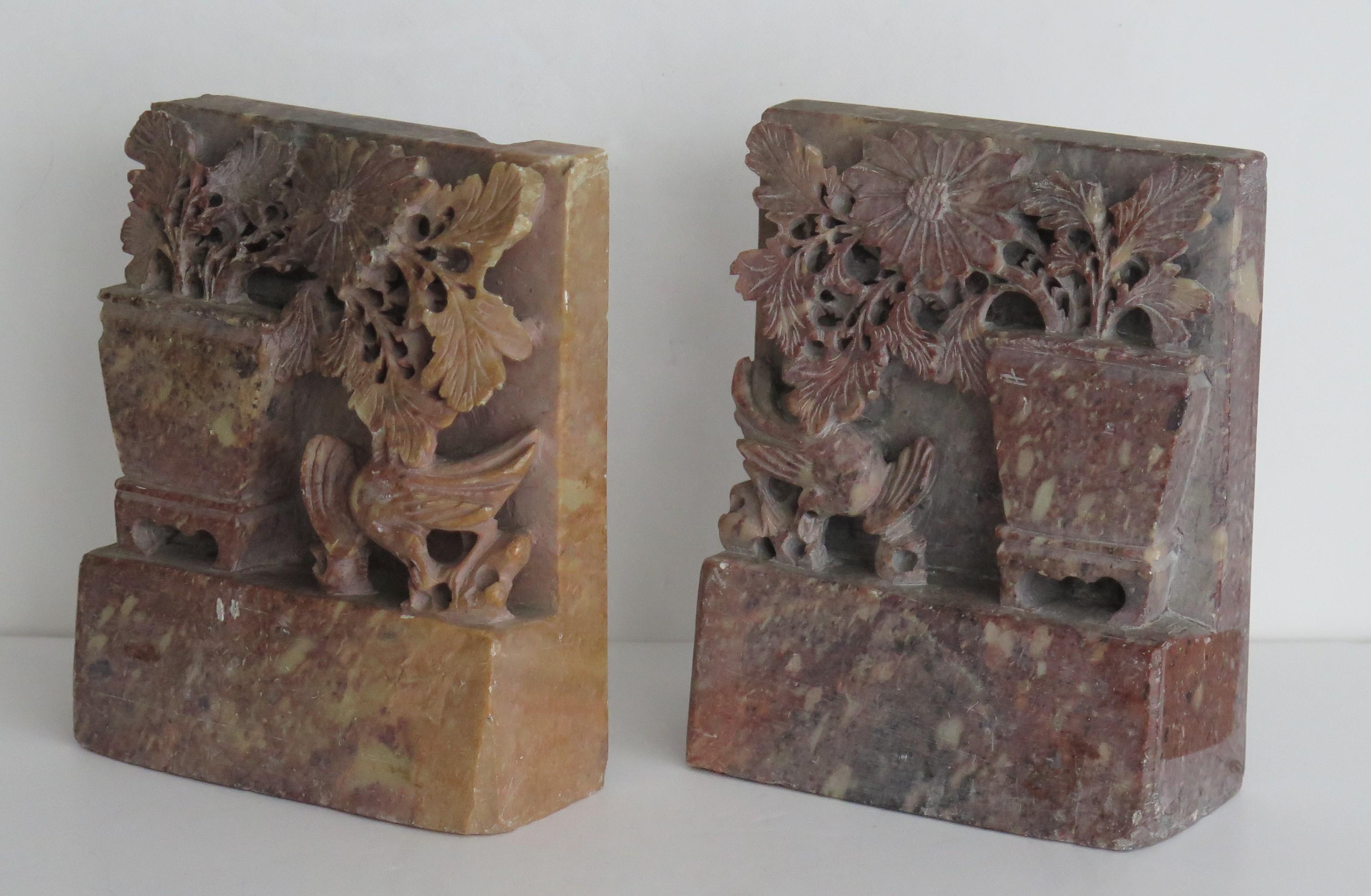 These are a beautiful pair of Chinese soapstone Bookends made in China during the Republic period, Circa 1920.

These bookends are individually well hand carved from the solid stone and depict a large vase of blossoming flowers and an exotic bird,