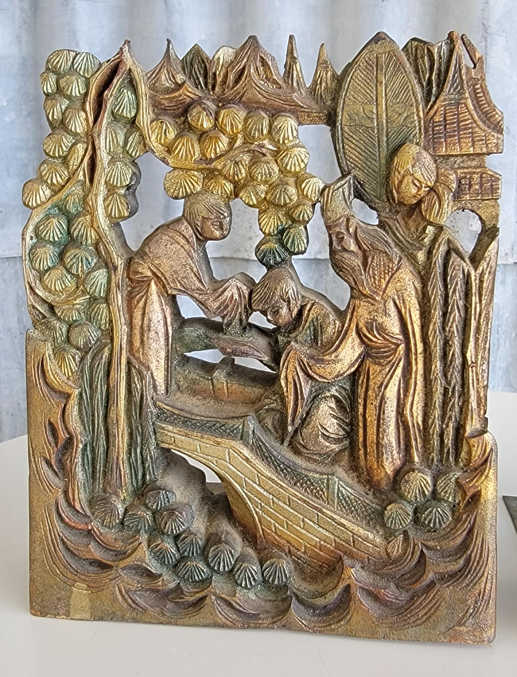 Hand carved bookends with a marketplace and figures motif. Early 20th Century. Original painted finish.