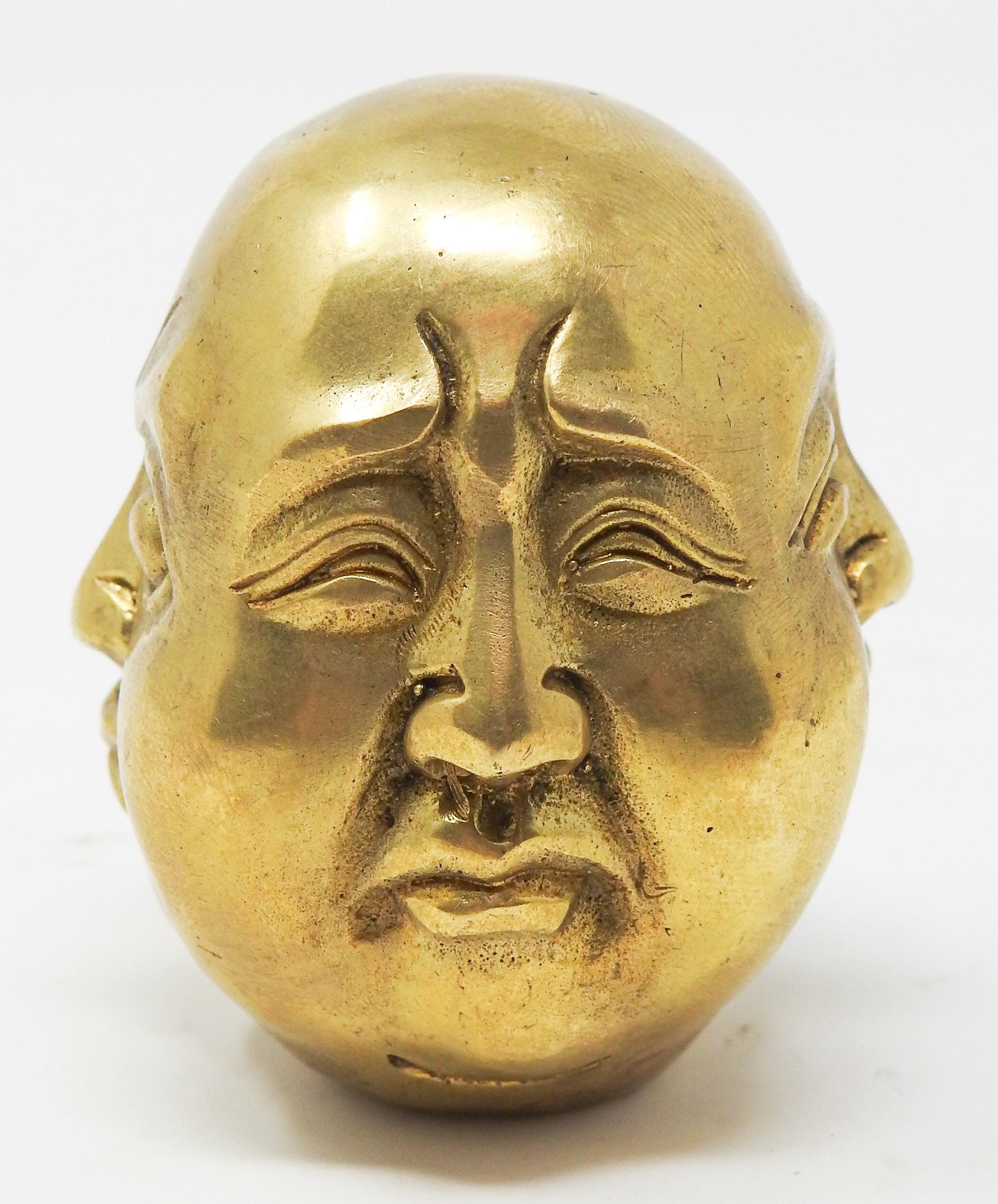 Offering this intriguing Chinese brass Buddha head chop seal. He has four different sides each depicting a different mood. He is done is solid brass. On the bottom there are four symbols which would be a signature of some sort and used to seal a