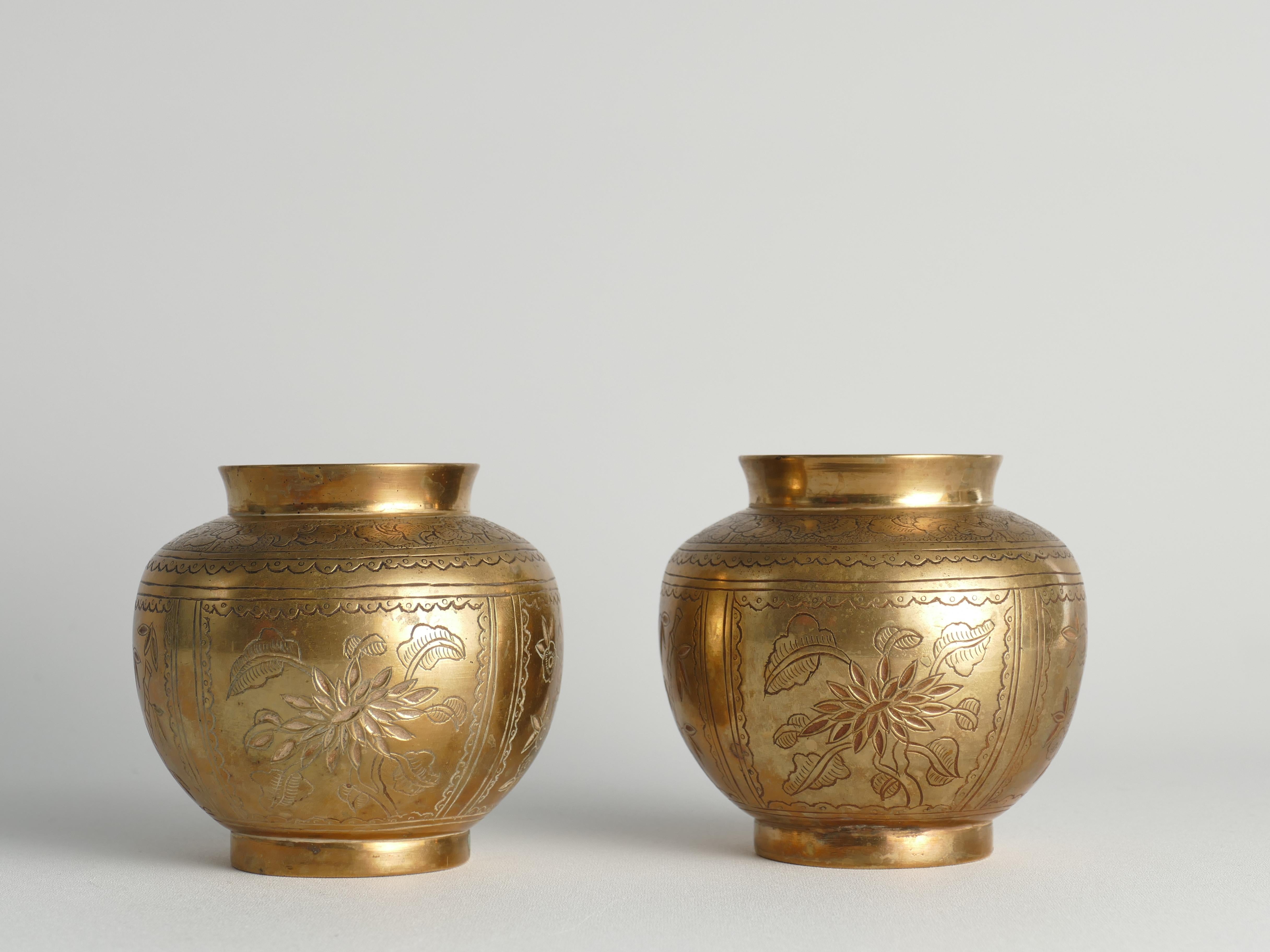 A pair of Chinese brass vases depicting the 