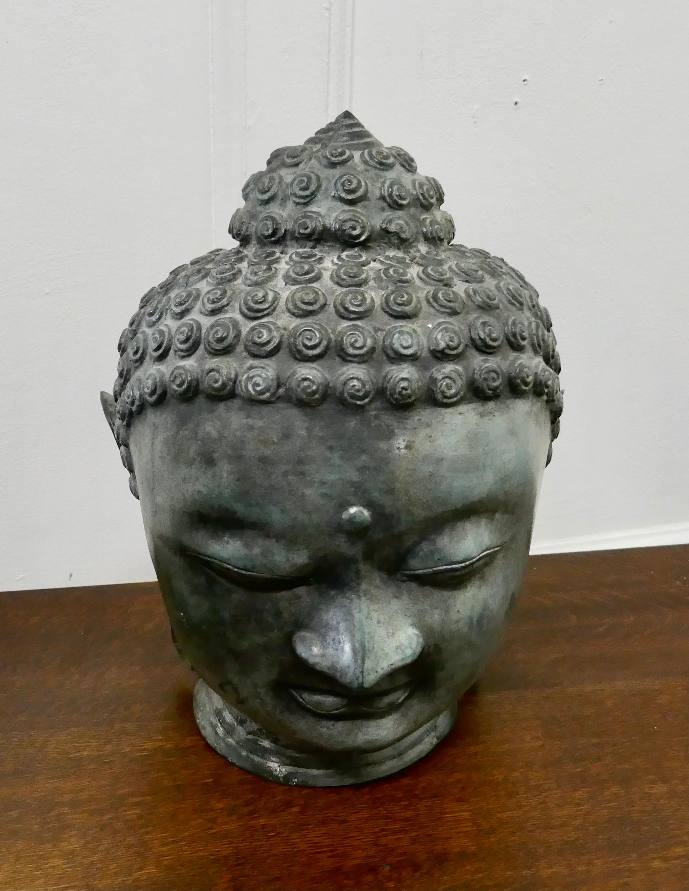 Chinese bronze Buddha head

This is an old artisan made piece dating from the 19th century, it is a three dimensional head in good condition with an aged patina
The piece is 12” high, and 10”/18” diameter
GB271.