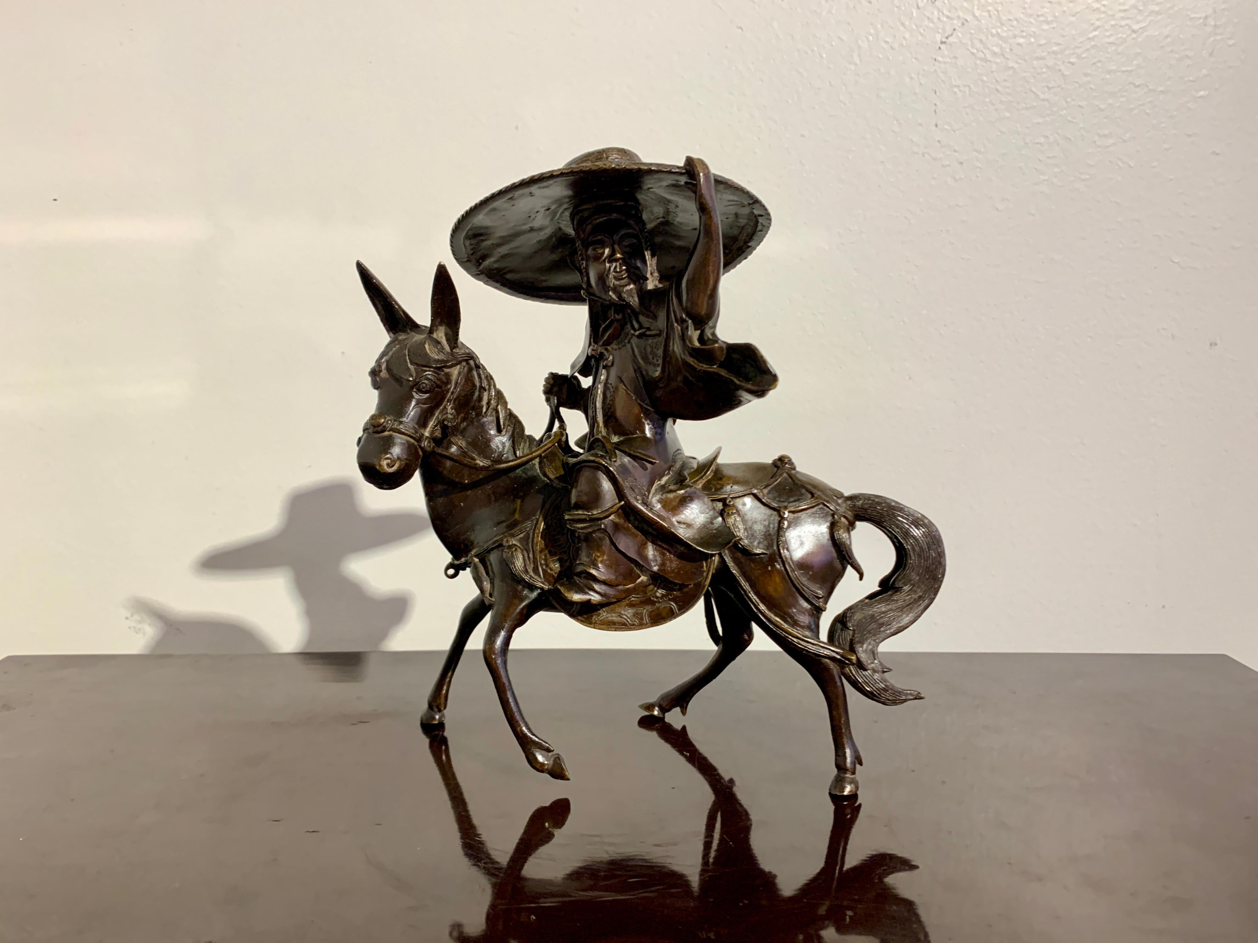A dynamic Chinese two part censer of a robed and hatted scholar or sage riding a donkey, Qing Dynasty, late 19th century, China.

The censer depicts a gentleman scholar, most likely the Song Dynasty literati figure Su Shi (Su Dongpo). The