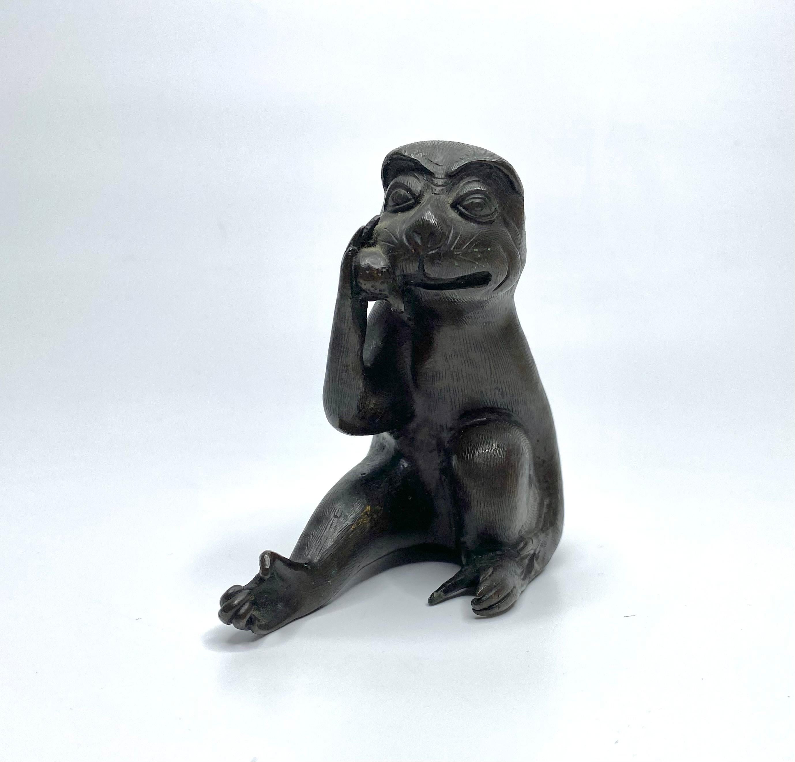 Chinese bronze figure of a Monkey, 17th Century, Ming Dynasty. The amusing study, cast as a seated monkey, about to devour a peach, held in his right hand.
His hair well delineated, and he bears a charming expression on his face.
Height – 10.2 cm,