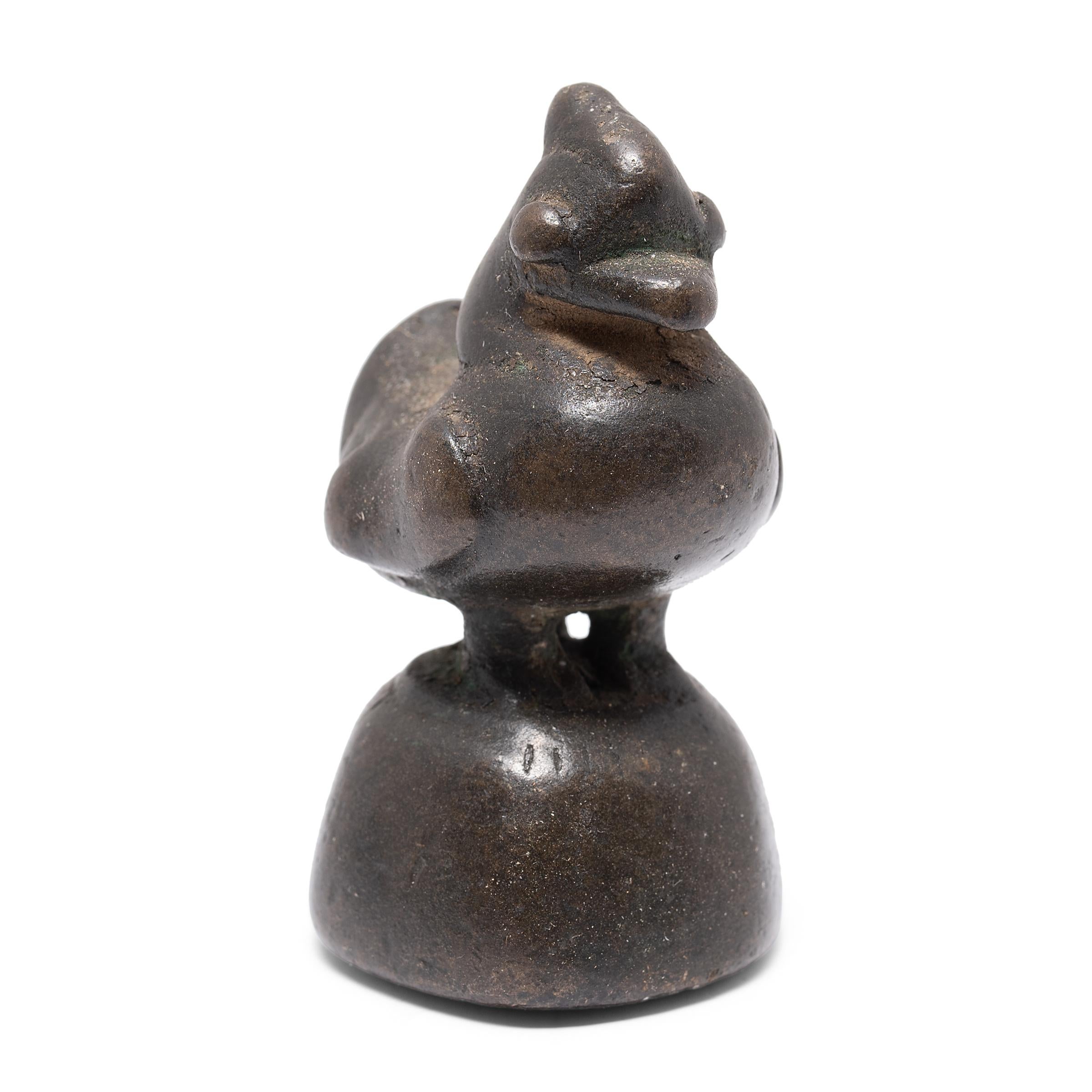 This small figurine was originally used as a counterweight for a tabletop balance, used to parcel out opium, spices, or other valuable goods. The petite weight is cast in bronze in the form of a rooster, the tenth symbolic animal of the Chinese