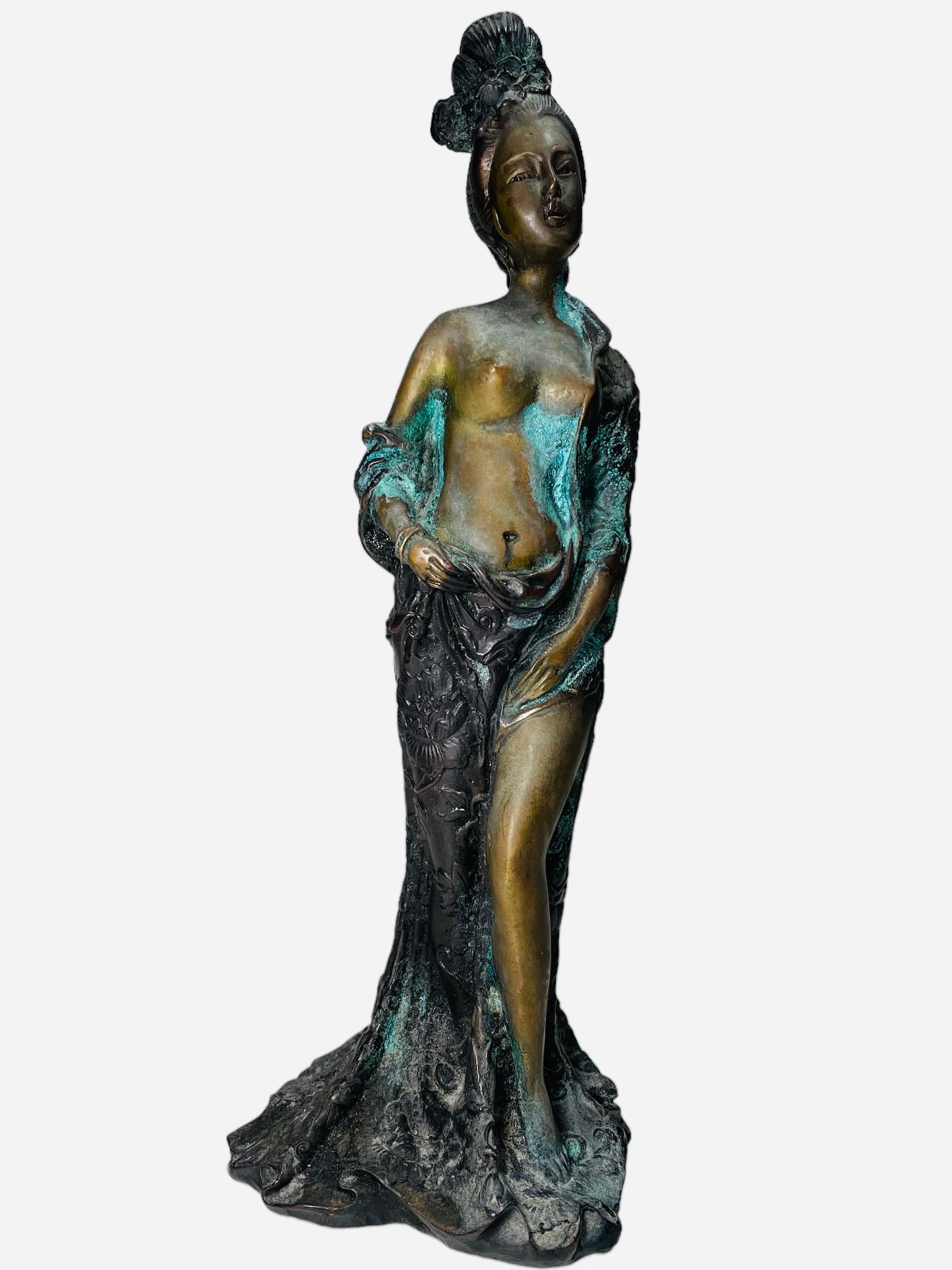 This is a Bronze Sculpture of a Chinese Lady. It depicts a semi nude Chinese lady standing up and wrapped with a robe around one of her shoulders, the back, below the hip and one of her legs. The robe is adorned with high relief of flowers. She has
