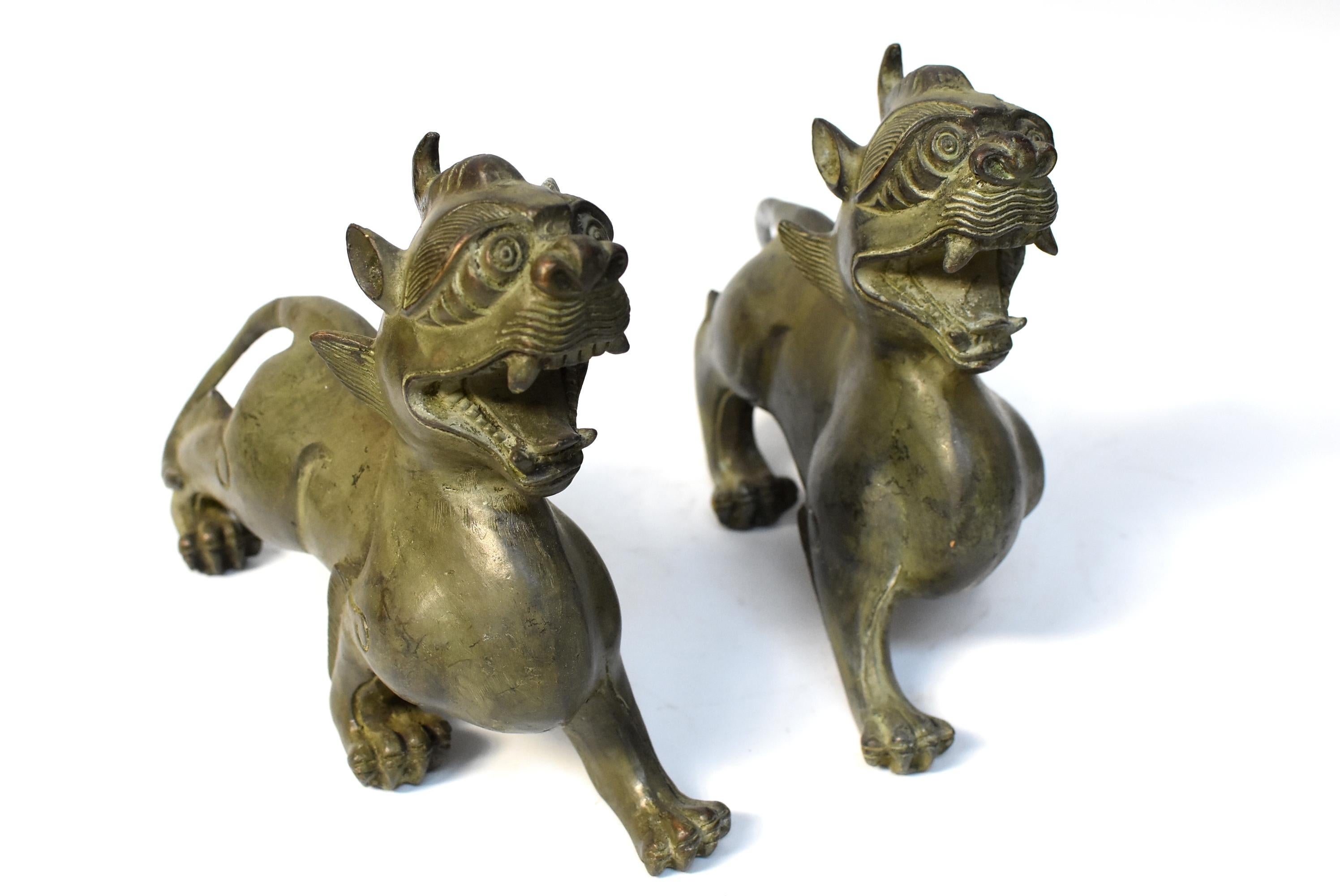 Pair of beautiful, large bronze Pi Xiu. The Pi Xiu is a mythical animal that is believed to safe guard and keep wealth. These statues are substantial and finely crafted. Masculine bodies, strong paws and tails, vivacious expressions.