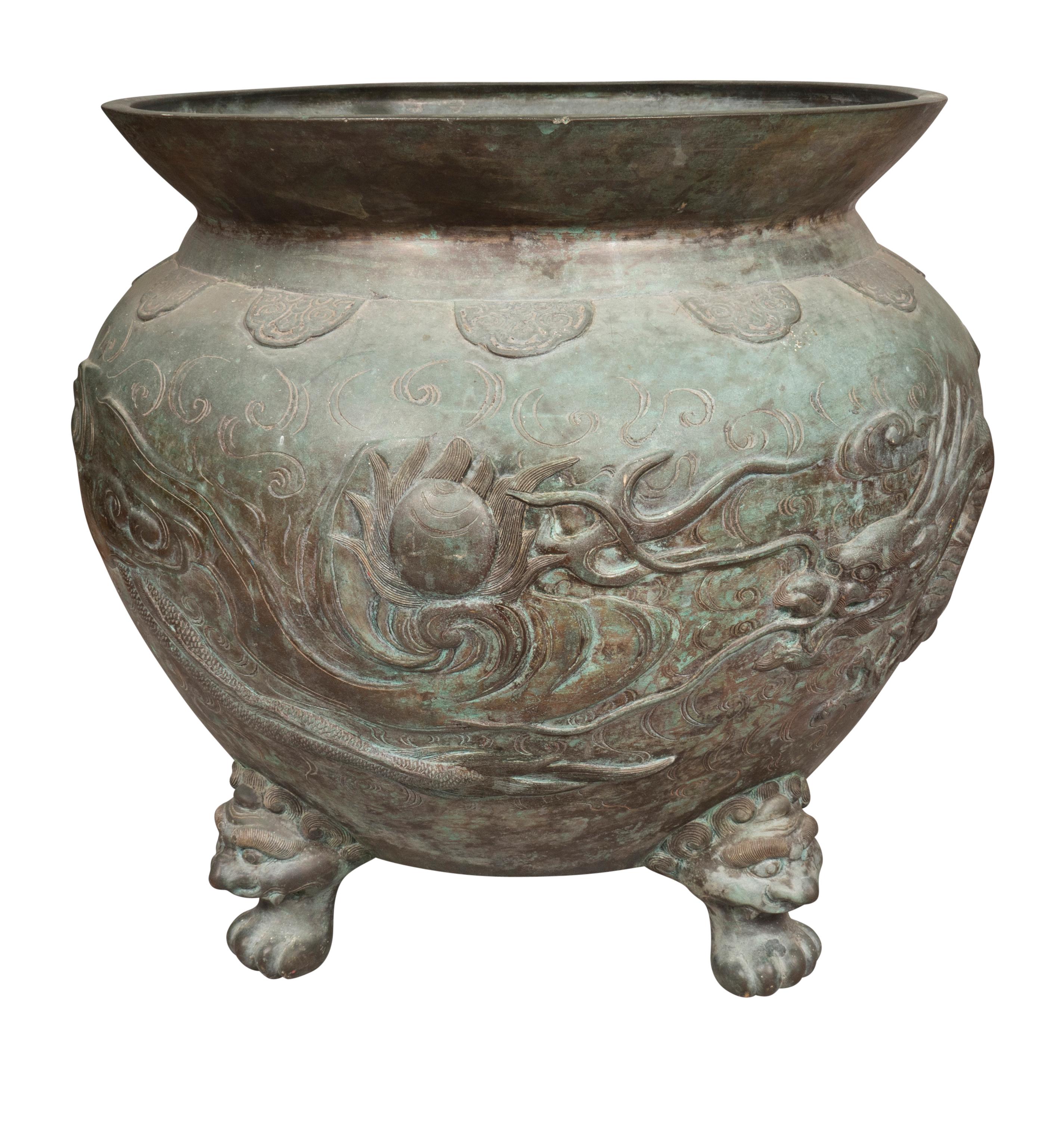 Globular form in vertigris patina decorated with dragons , clouds and the sacred pearl. The dragon and the pearl is a common Chinese image and a well known story in Chinese folklore. Buddhistic dog feet.