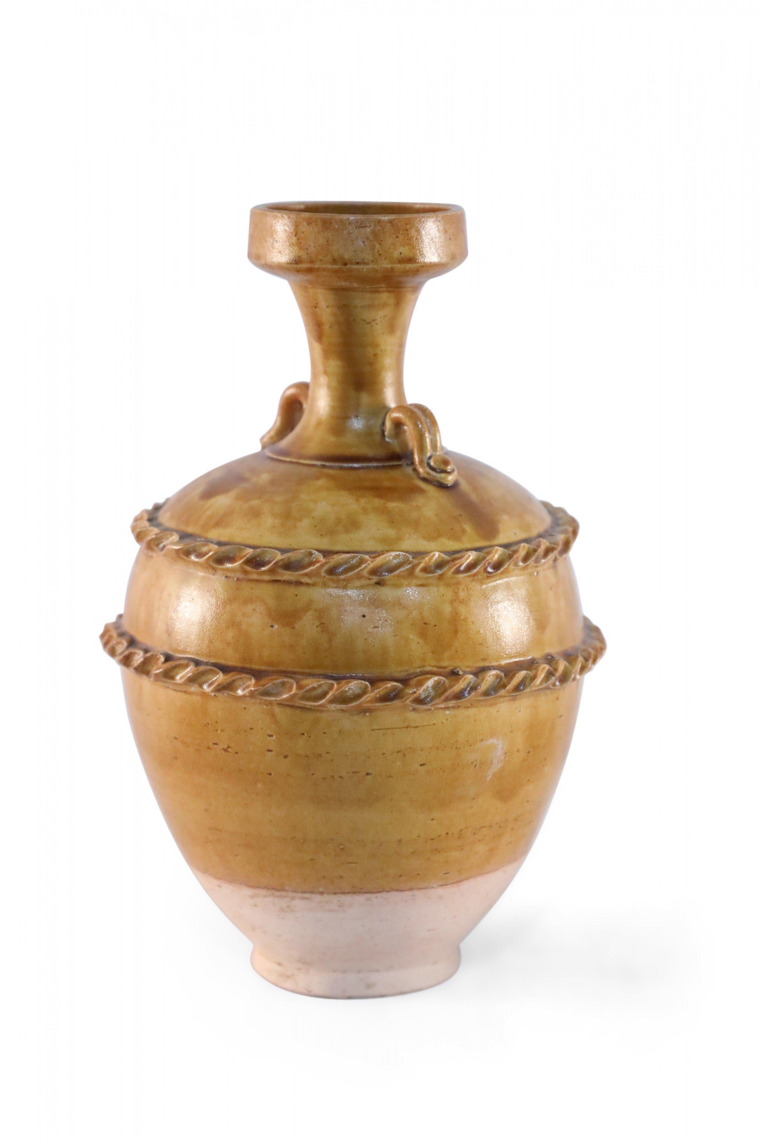 Antique Chinese handled vase with a pale pink base and a burnished tan body showing highs and lows in the finish, wrapped in two ribboned rope-like bands.
   