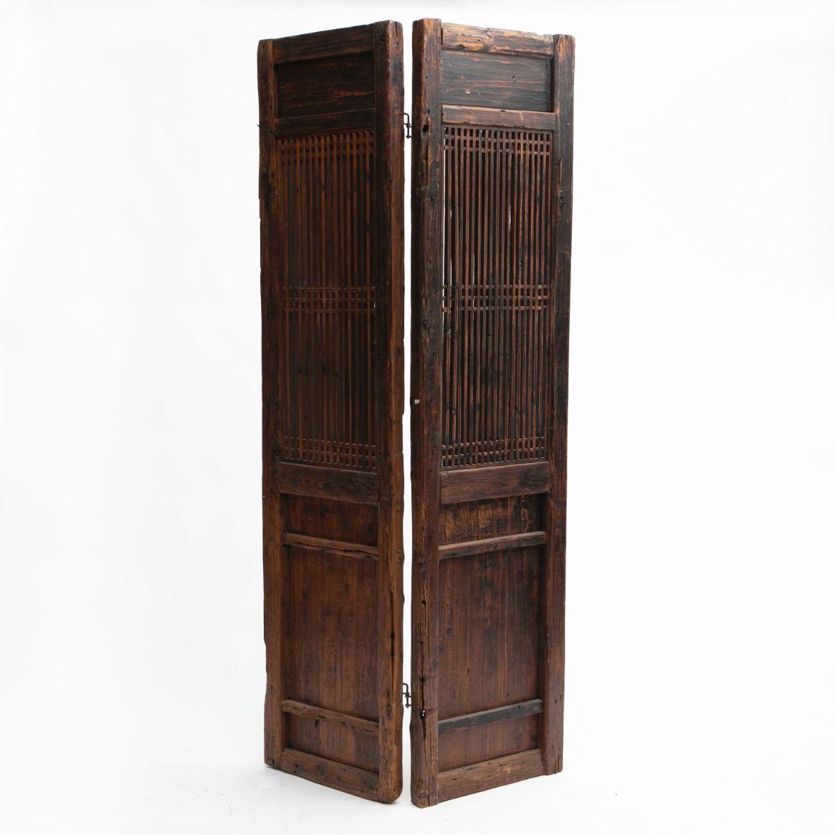 A pair of Qing dynasty wall screens / room dividers crafted from pine with remnants of rich burgundy lacquer.
These screens showcase high-quality joinery with intricate wooden slats and panels that add elegance to their traditional design.
They