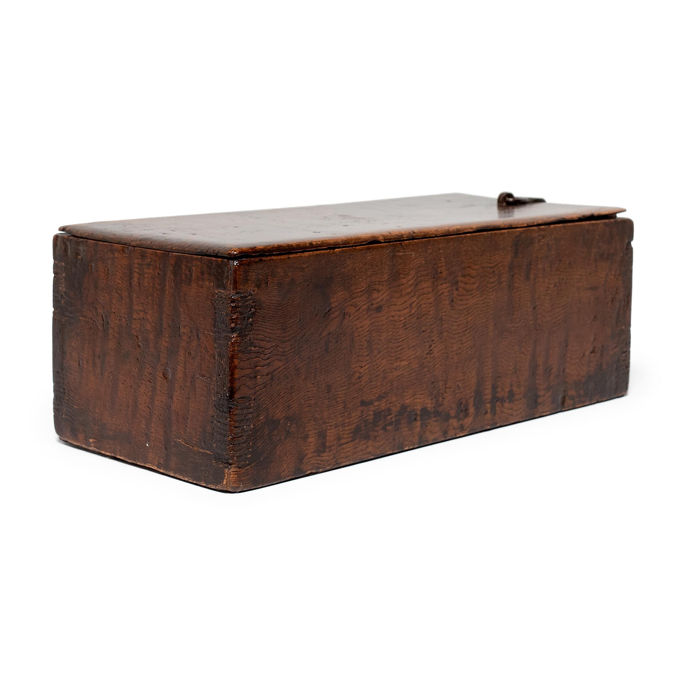 Crafted from a beautiful specimen of burled northern elm (yumu), this wooden document box likely once sat in the studio of a Qing-dynasty scholar-official. The perfect size for a rolled-up scroll, the box was used to store and protect works of