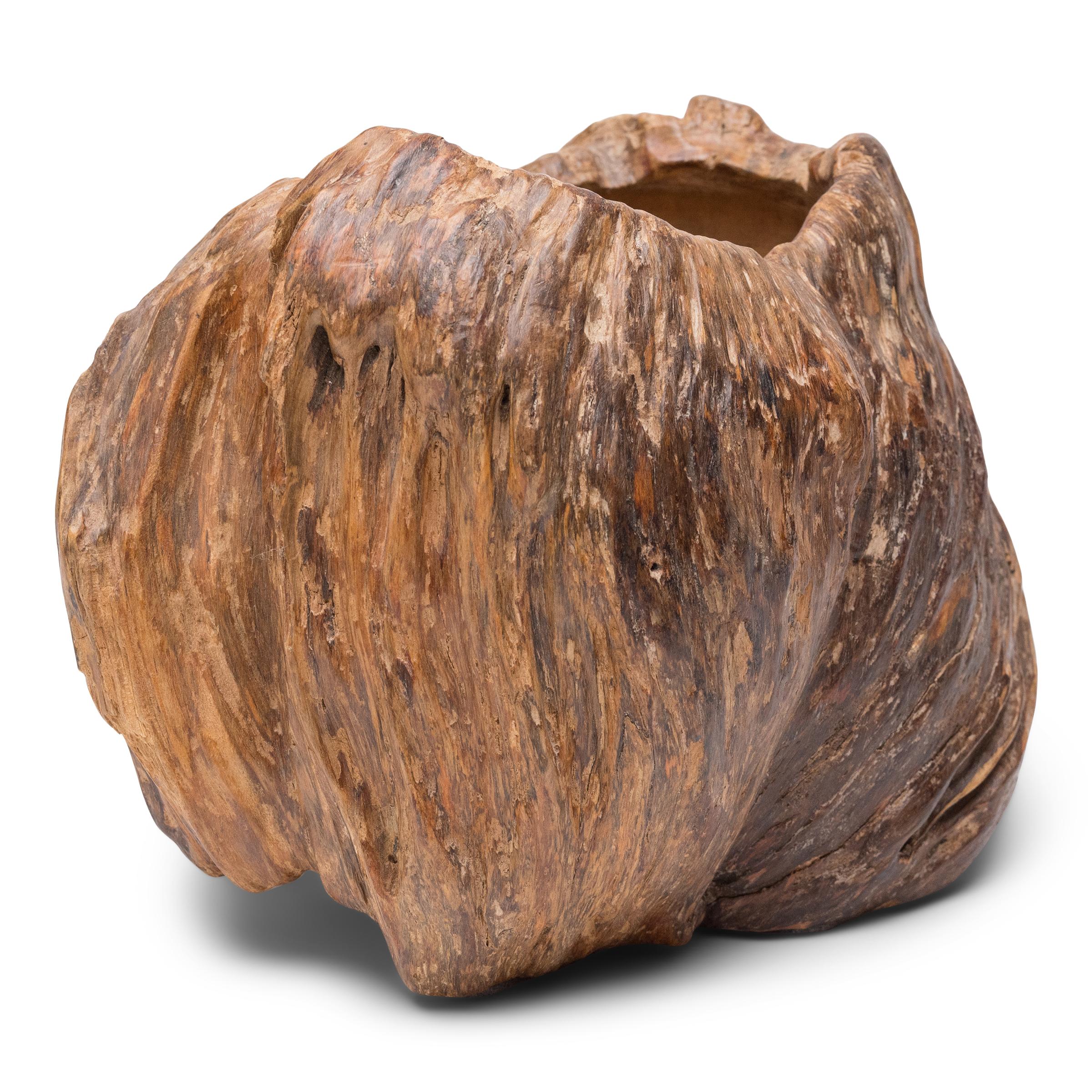 Carefully carved from a cypress tree burl, this late 19th-century burlwood vessel is known as a brush pot, a container traditionally used to hold select calligraphy brushes in a scholars' studio. Placed alongside the Four Treasures of the scholar -