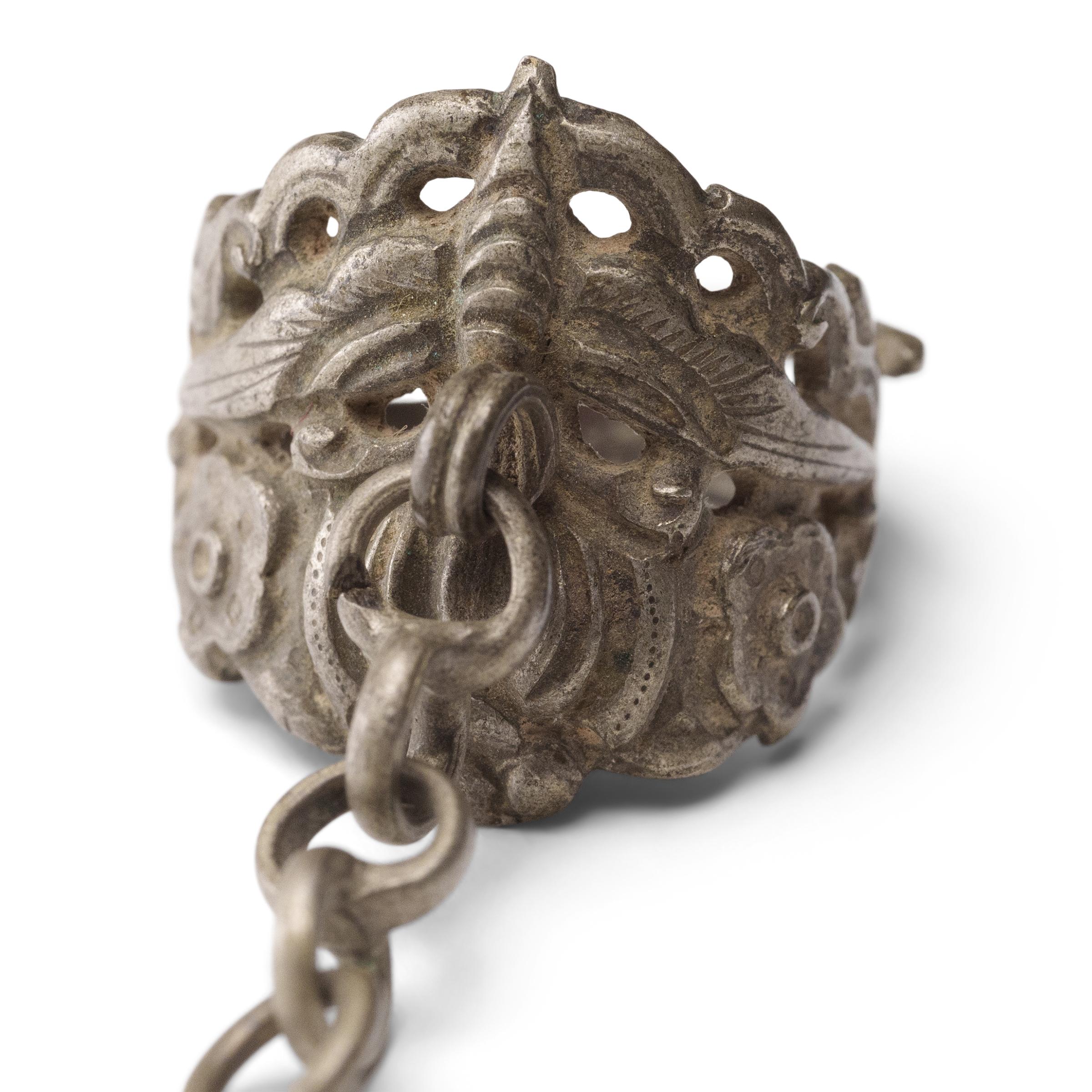 Dated to the late 19th century, this silver charm ring was crafted by the Miao peoples of the Guizhou province and was believed to protect the wearer from bad luck and malevolent spirits. The ring is decorated in relief with a round gourd and a