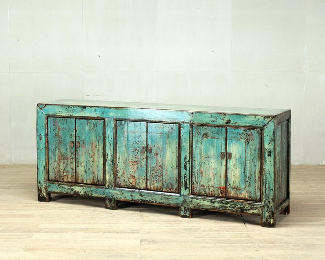 This cabinet was made from reclaimed pine wood with traditional nail-less joinery. The piece still has a turquoise color that is still visible and has been enhanced with a sophisticated French polish finish. The piece was restored in a workshop