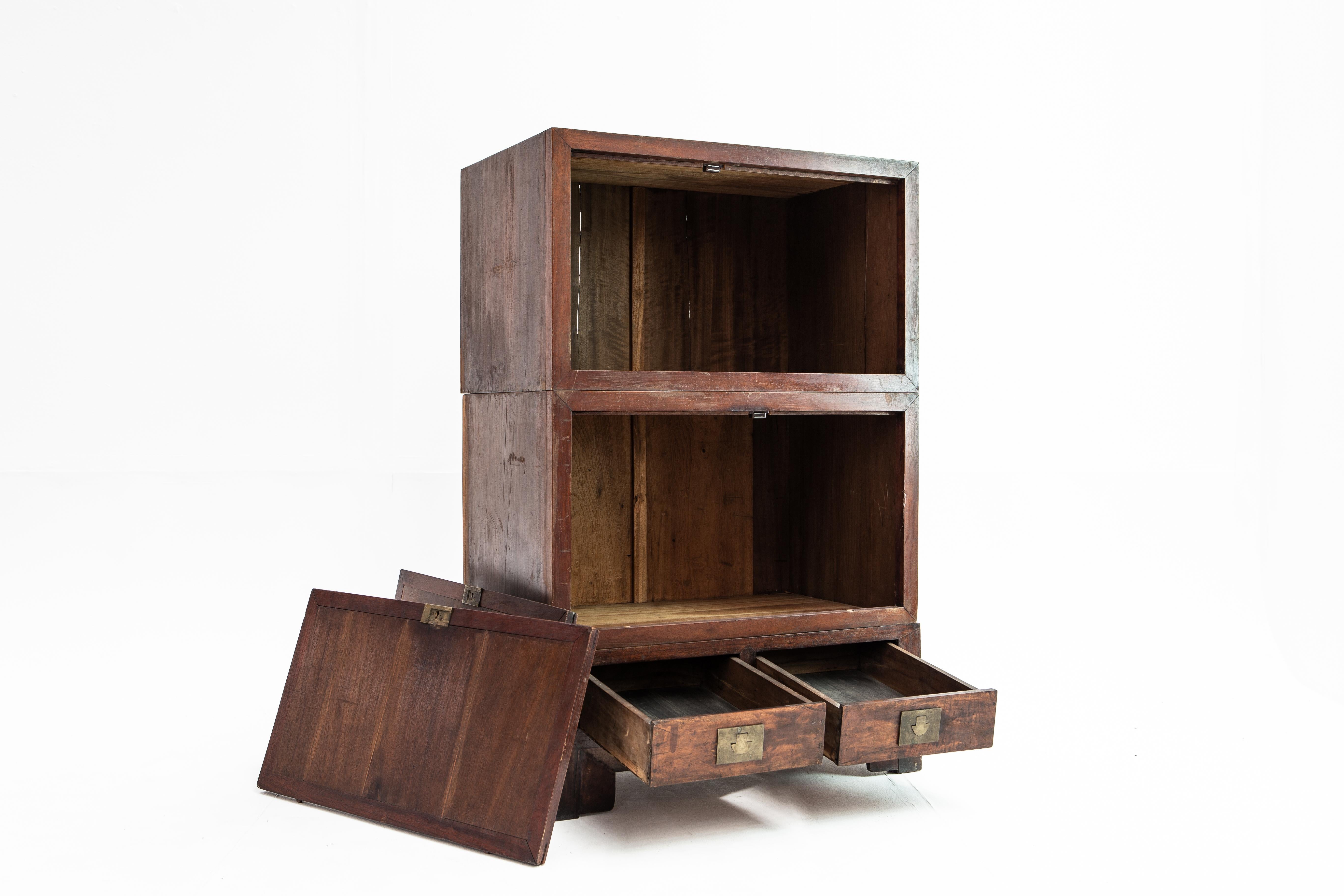 This three-piece cabinet was likely intended to hold books, as bookshelves were an important element in a Chinese scholar’s library. The clean lines are enhanced by simple hardware and the piece’s original patina. Two drawers provide additional