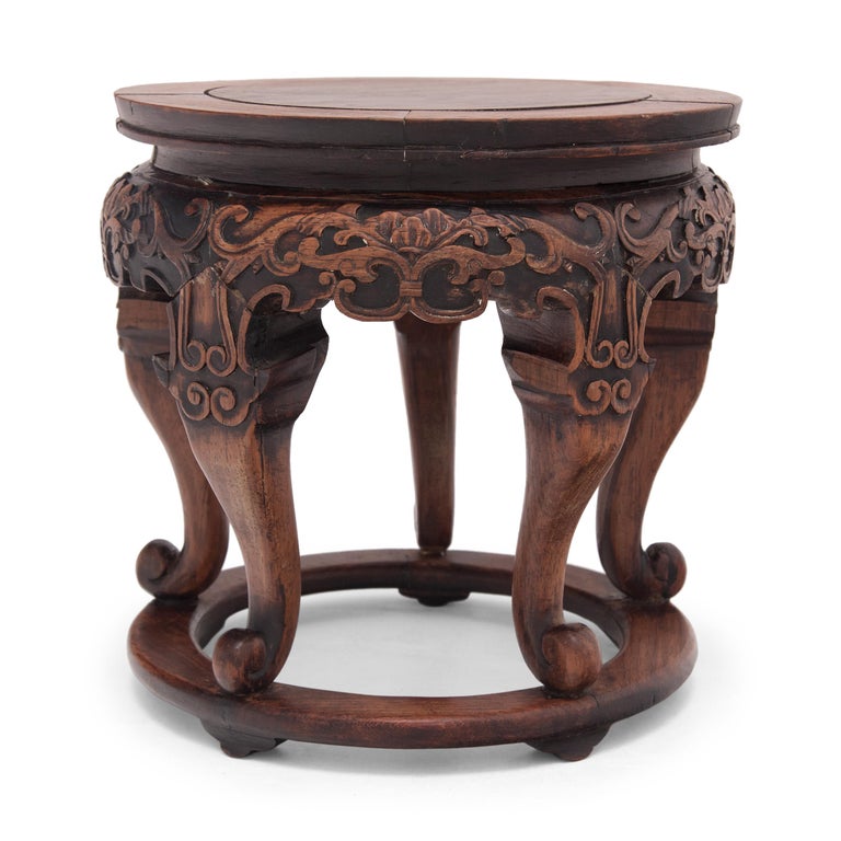 This petite display table dates to the late 19th century was originally used to elevate incense burners or decorative objects. Hand-carved of fine huali rosewood, the pedestal has a round, waisted top and five cabriole legs resting on a circular