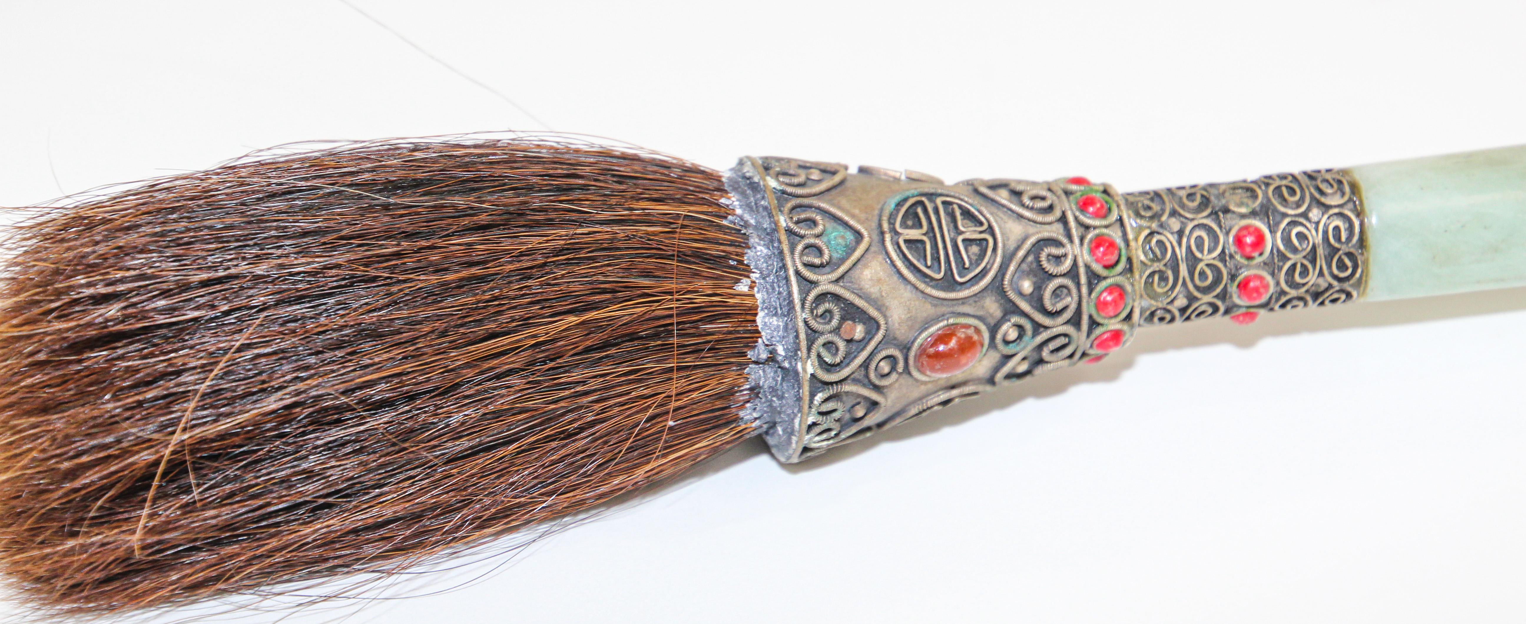 Beautiful hand made large Asian calligraphy art brush with natural hair bristles.
The handle is quite extraordinary; made of jade green soapstone, the metal knob very beautiful detail in the metal filigree designs and red stones with horse hair.