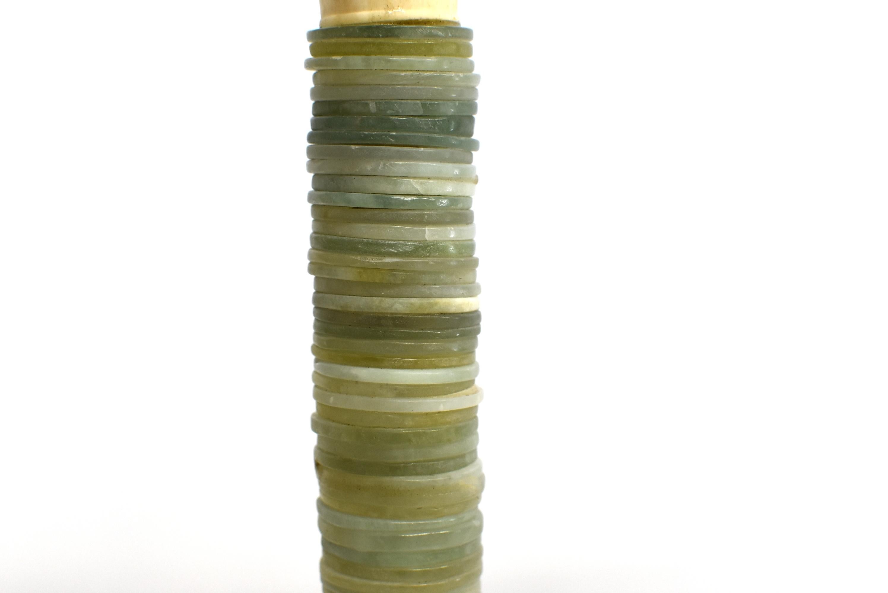Beautiful large Chinese calligraphy brush with stack of 60 hand carved jade disks. This is an oversize brush displaying a great collection of jade of various color and origin. A very special piece that is at once functional as a painting or