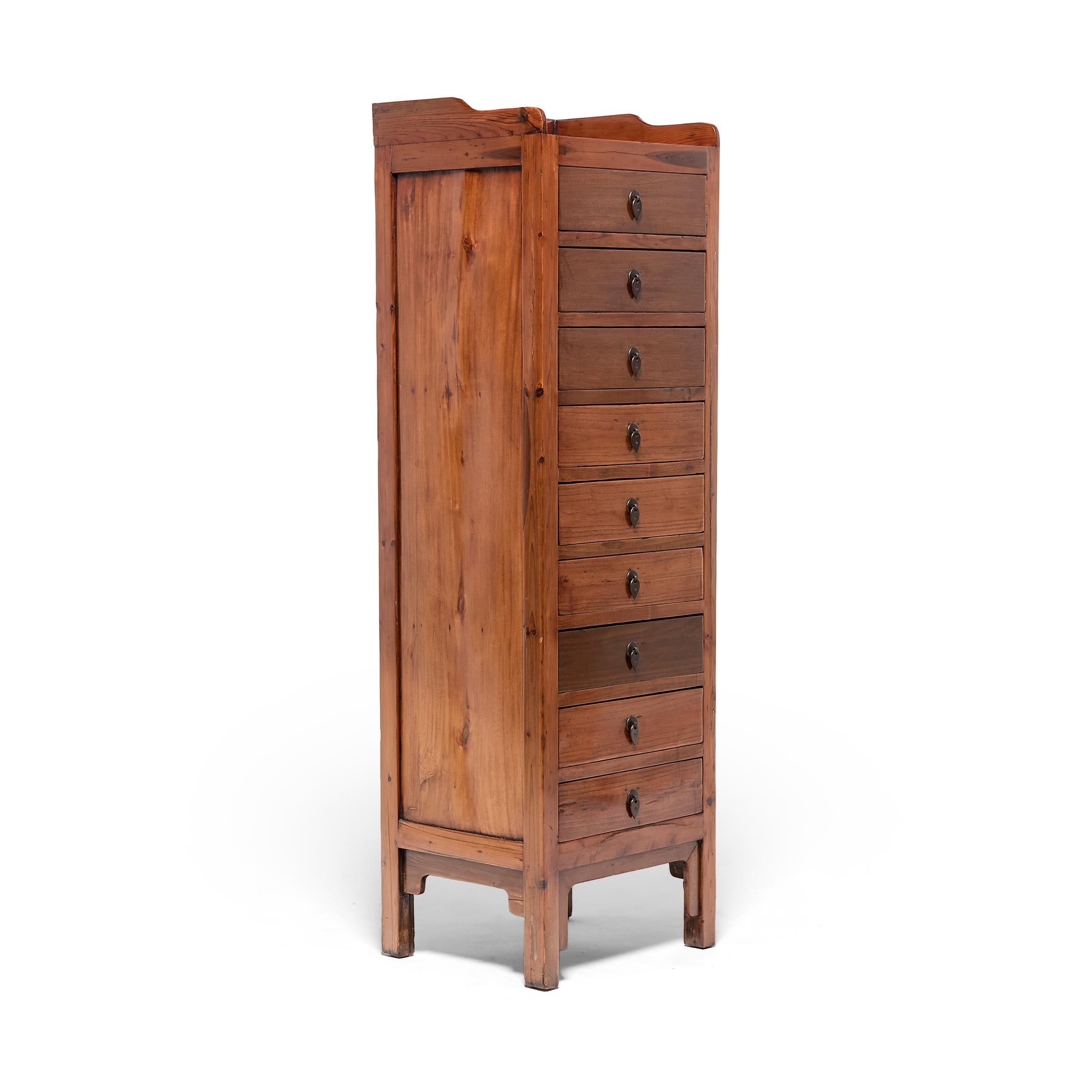 Just like contemporary flat-file storage, this tall camphor chest once provided a Qing-dynasty official or businessman with ample storage to organize flat documents and important papers. Dated to the late 19th century, the upright cabinet has nine