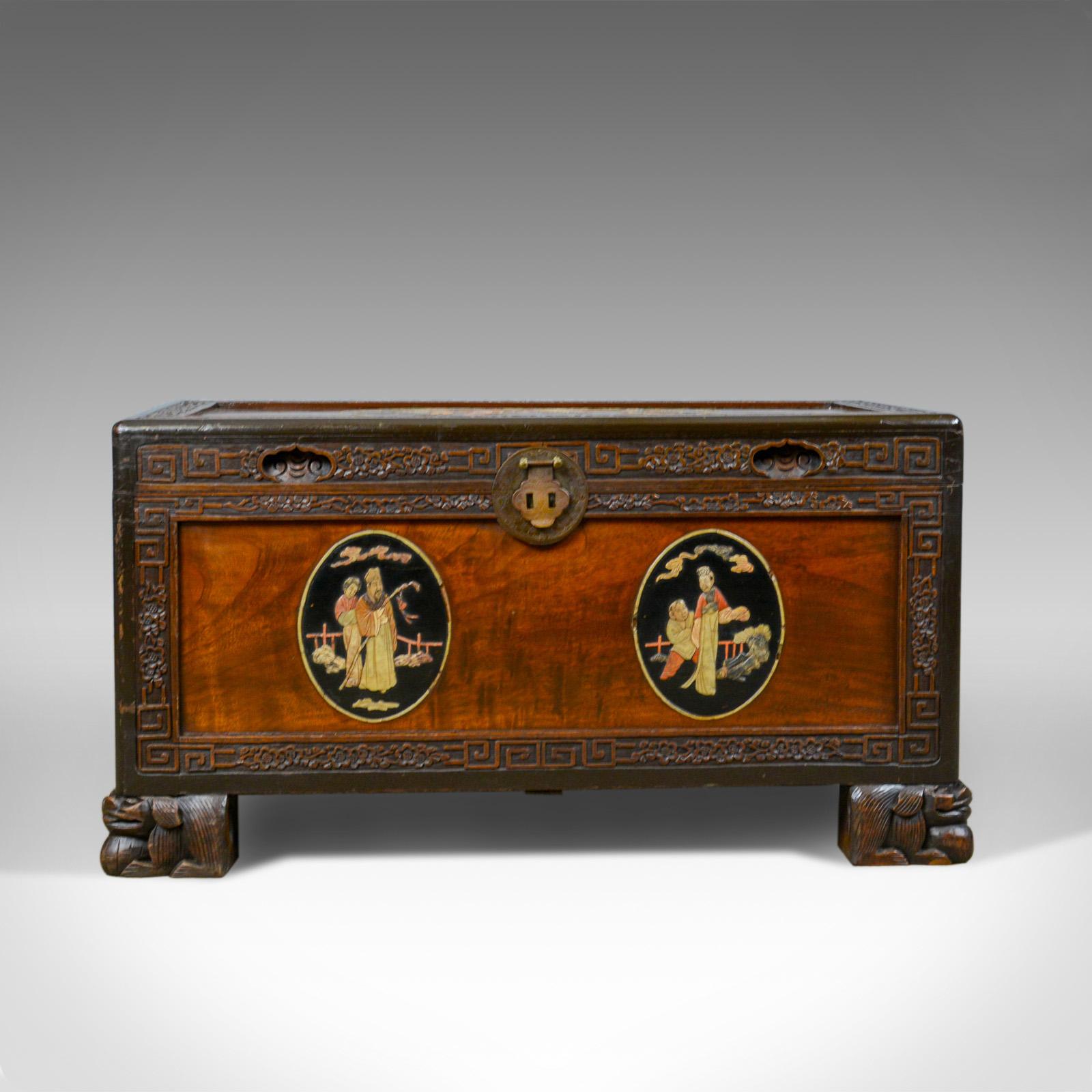 This is a Chinese camphor wood chest with oriental inlaid scenes. A trunk dating to the Art Deco period of the mid 20th century, circa 1940.

Fabulously decorated with inlaid panel scenes
Delineated with foliate carved perimeter bands 
Standing